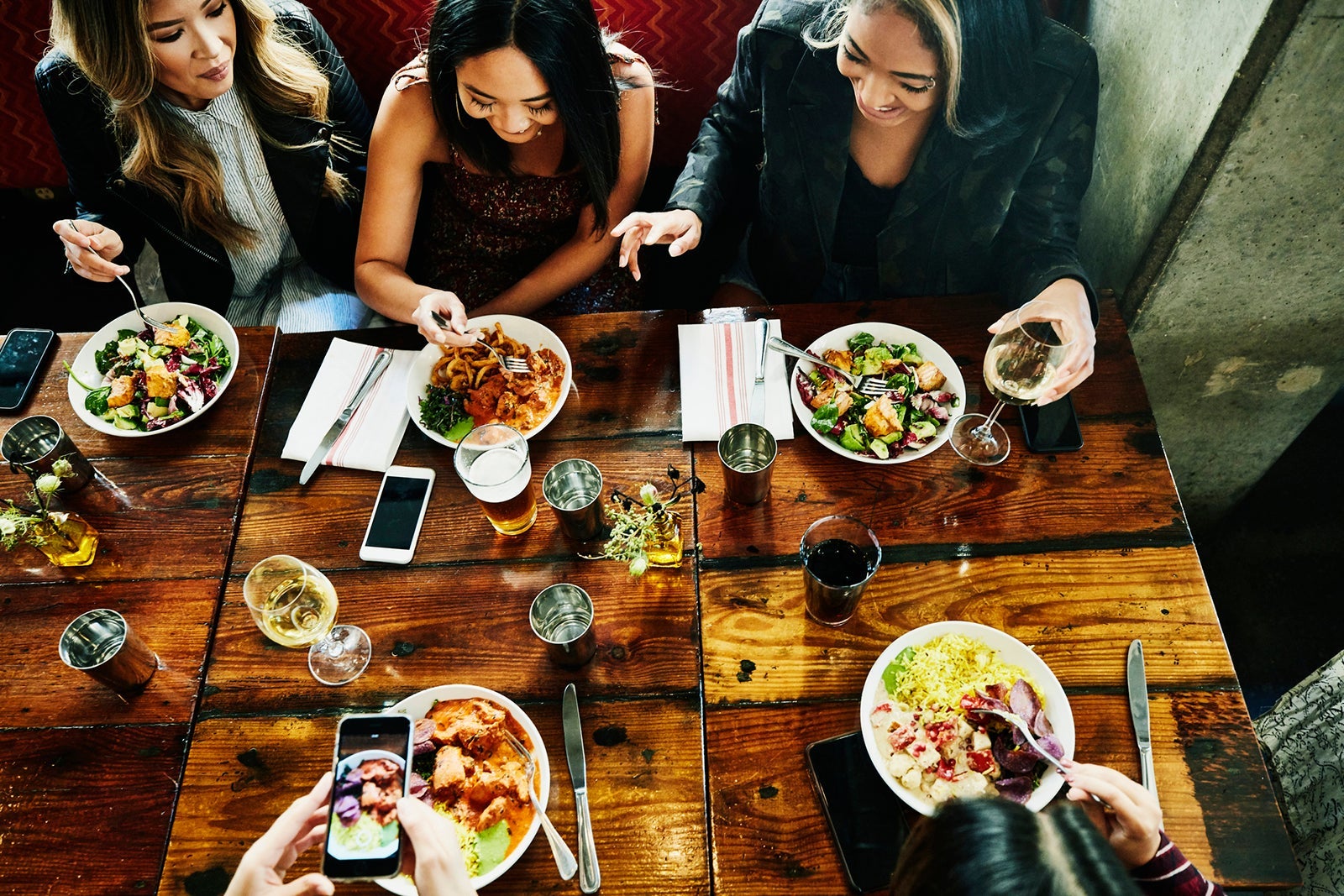 Female freinds sharing lunch at restaurant Thomas Barwick