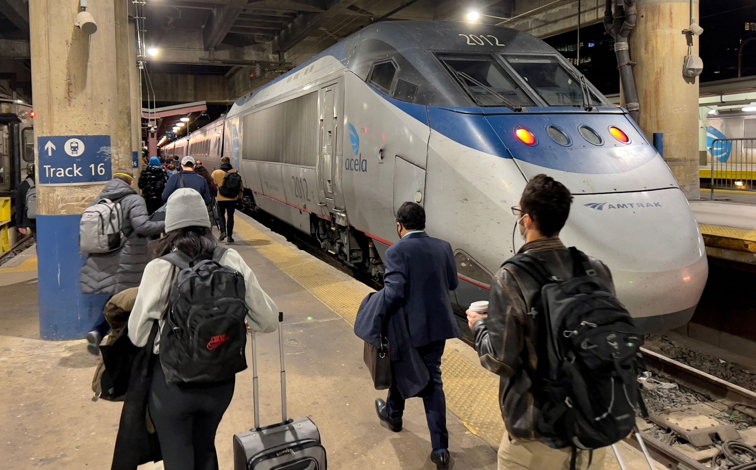 People boarding an Amtrak Acela train