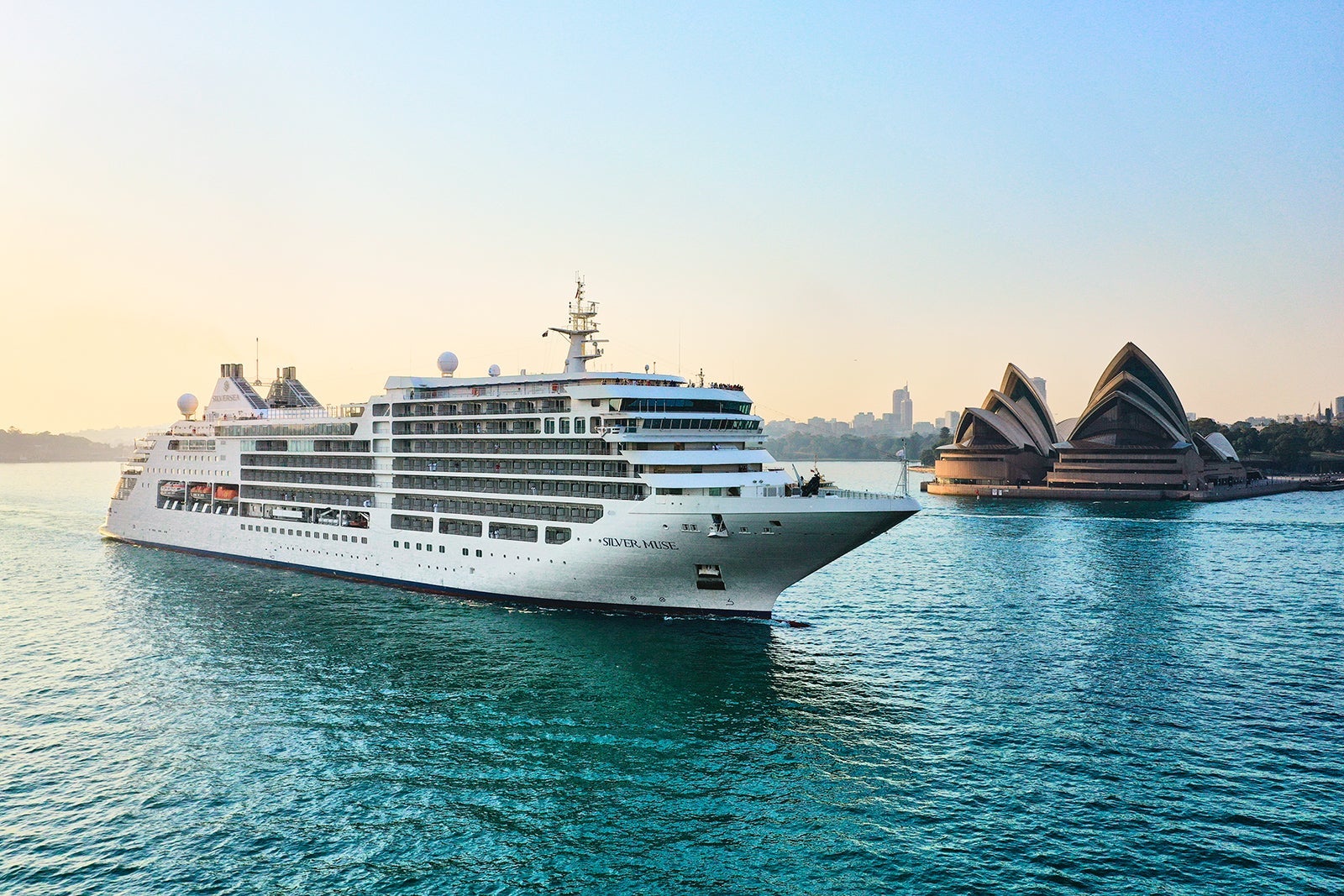 A cruise ship sailing past the Sydney Opera House in Australia