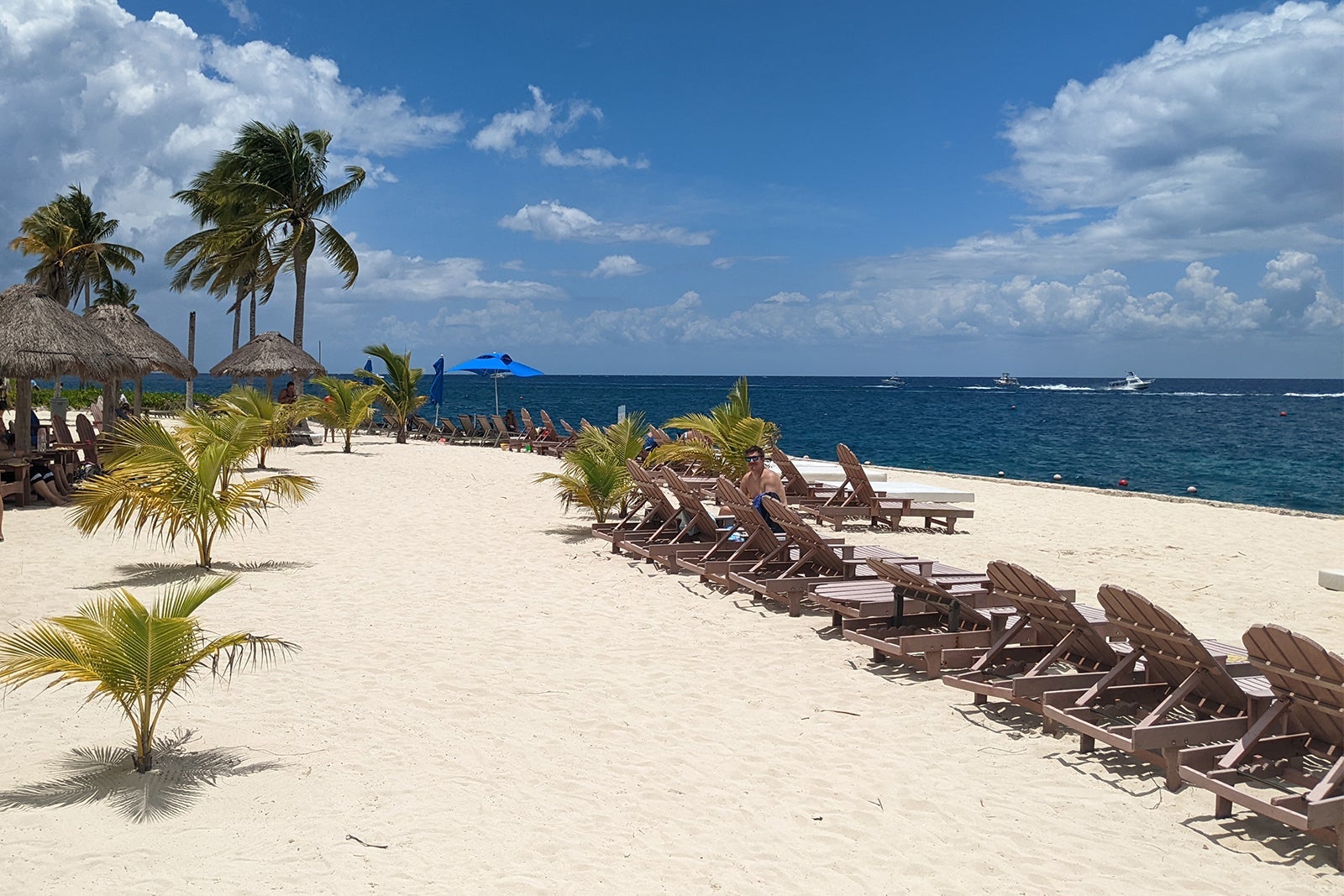 Chankanaab beach with lounge chairs and palm trees