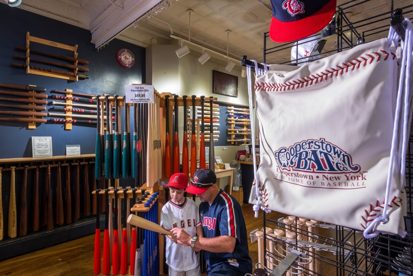 Child looking at baseball bats in store