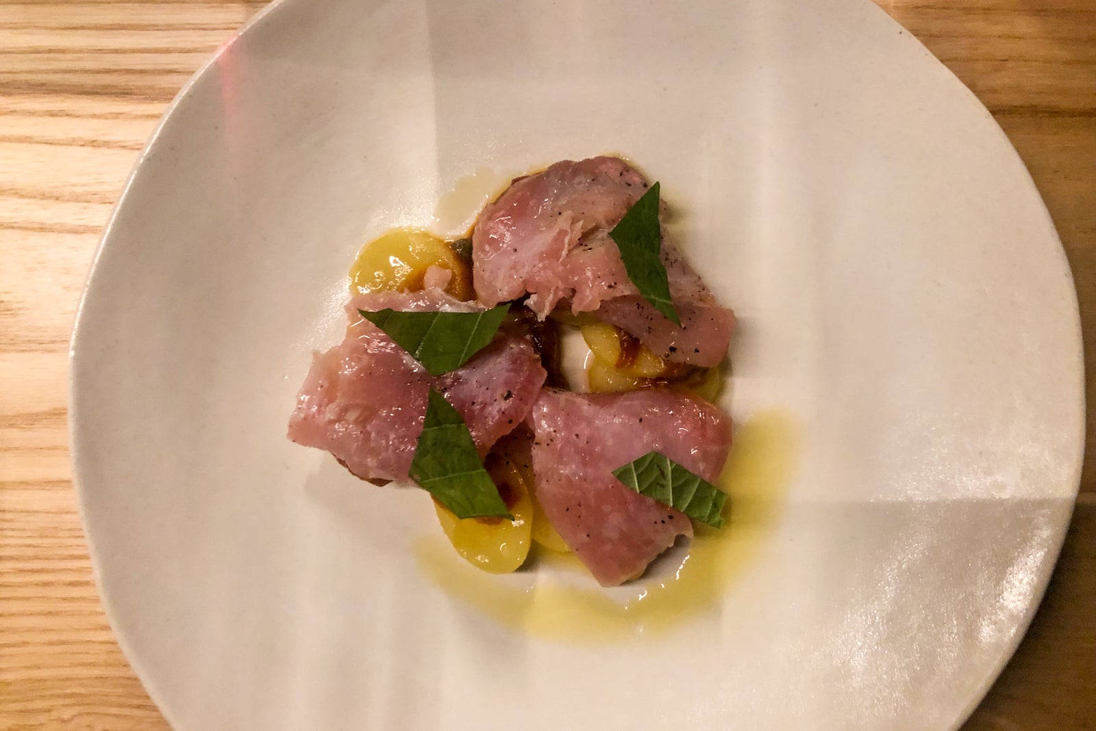 Photos of the menu and three different dishes at Tomo Seattle.