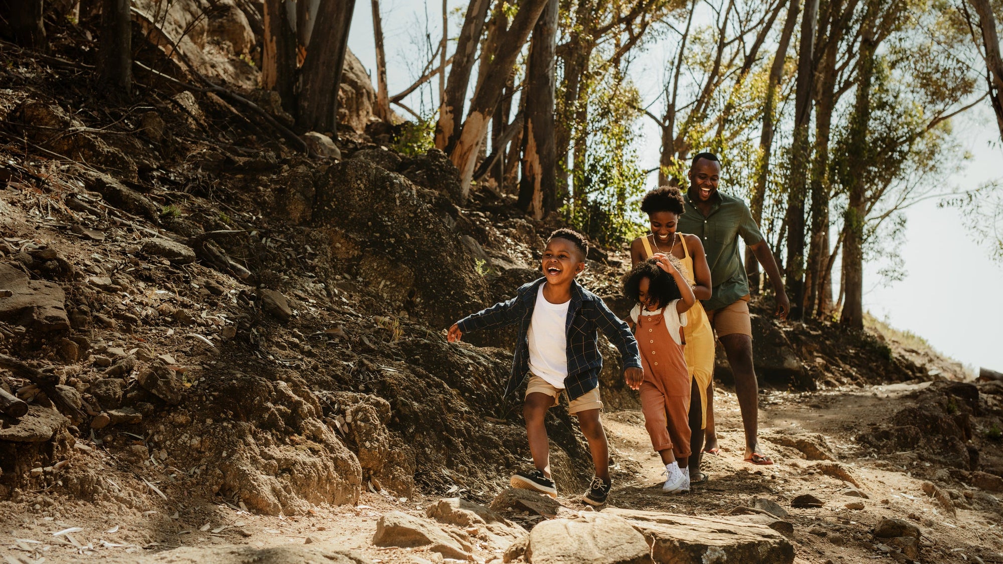 Family running down rocky trail