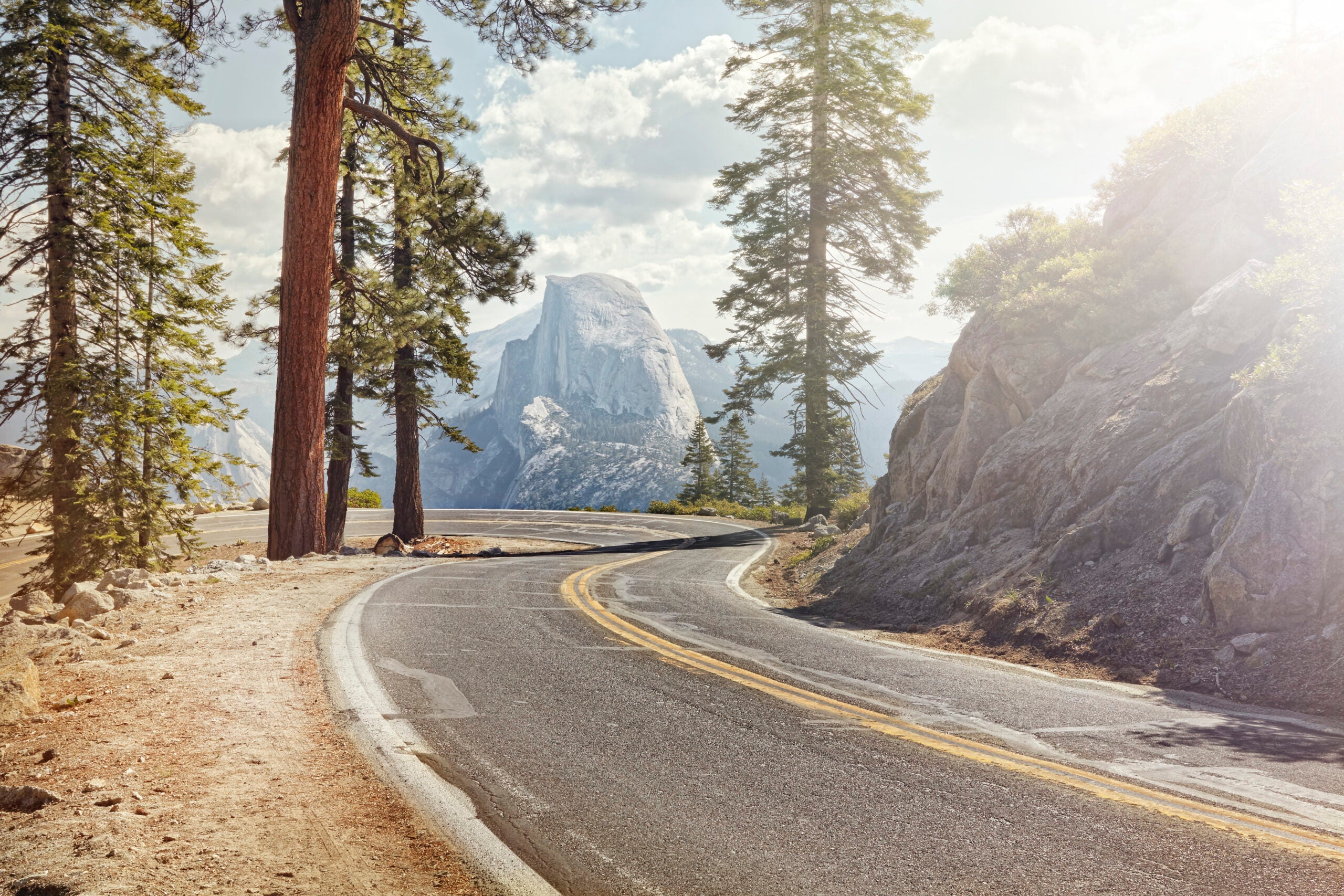 Winding road with half dome in yosemite.