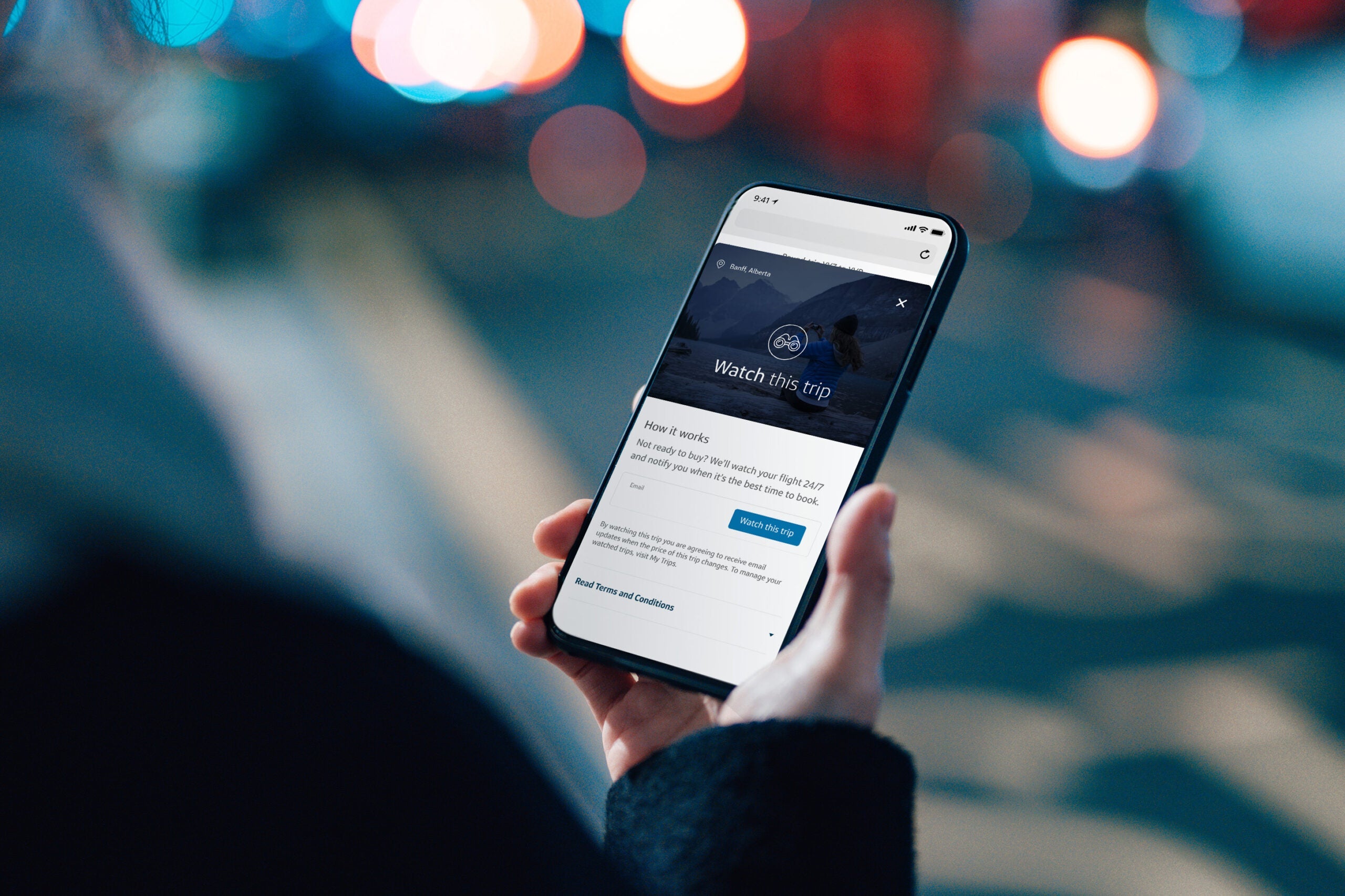 A person is looking at their cellphone on the Capital One Travel app, watching their trip.