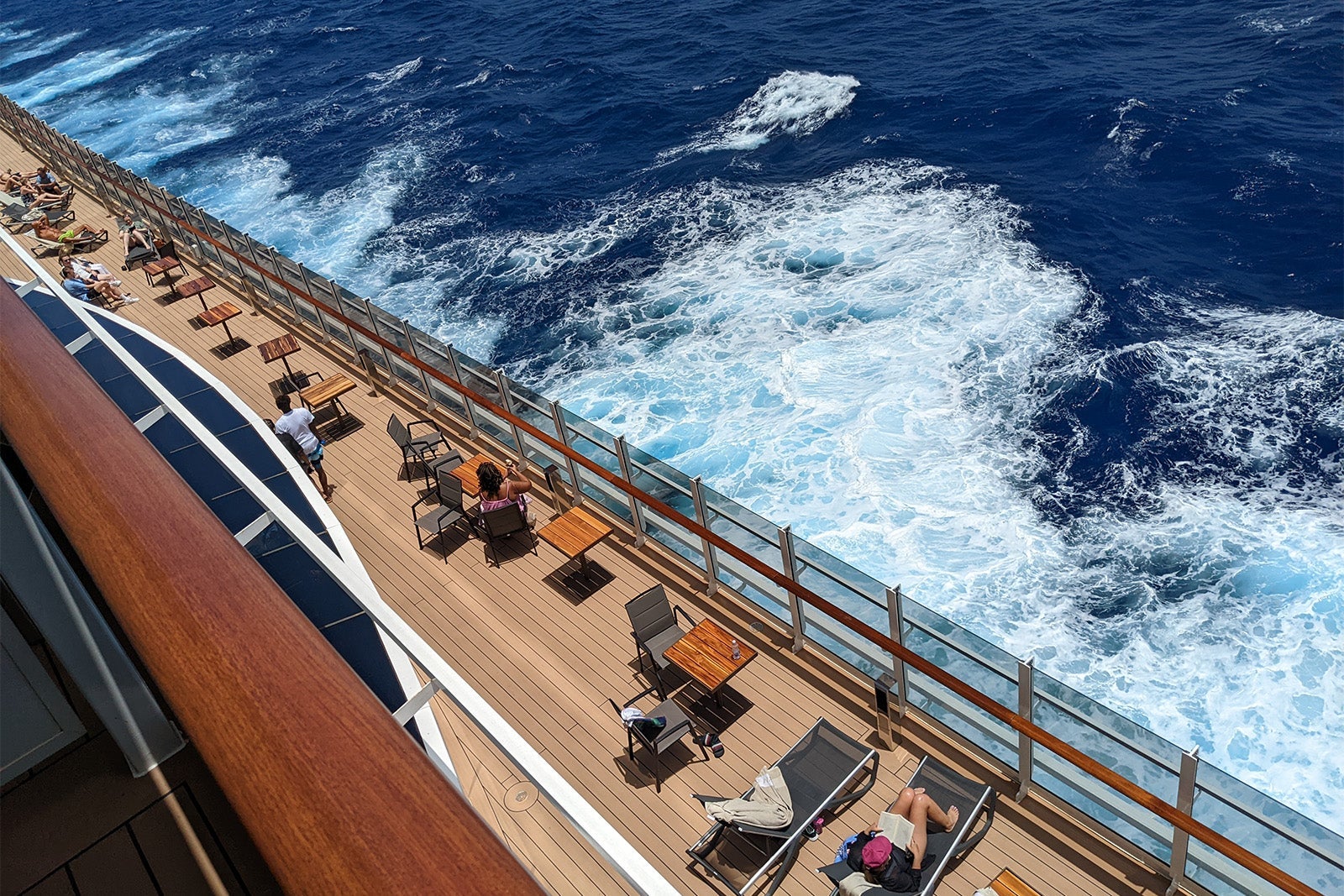 Promenade deck with tables and lounge chairs on MSC Seashore