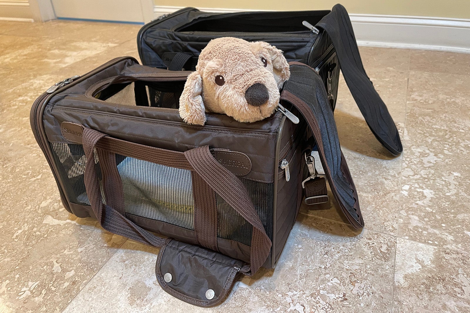 Sherpa Original pet carrier shown in medium and large sizes with a toy puppy in one.