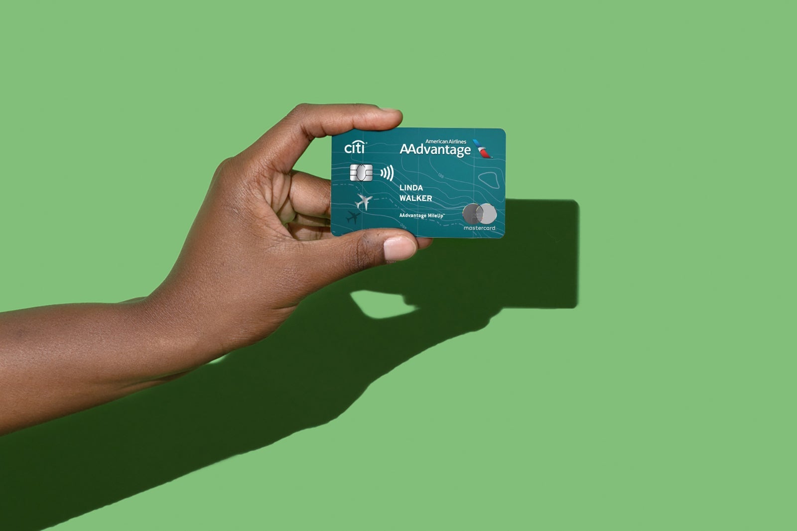 A hand holds the American Airlines AAdvantage MileUp card