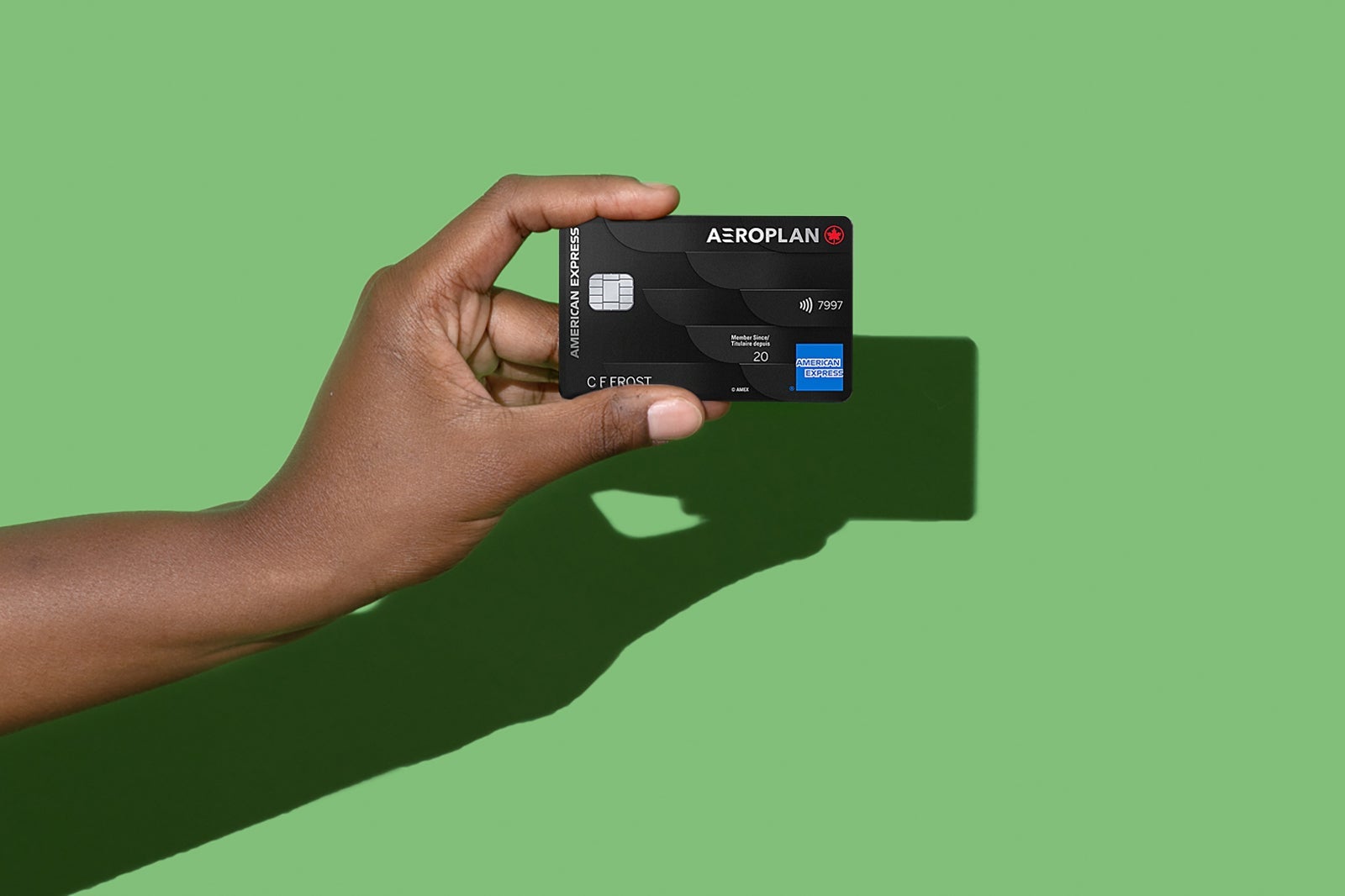 a hand holds a credit card