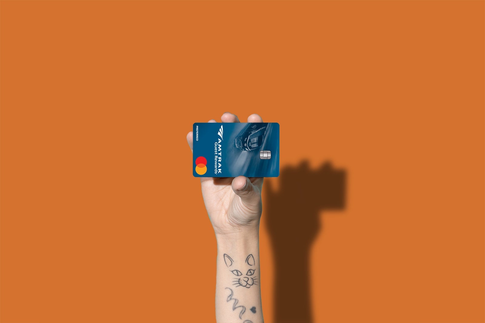 a hand holds a credit card