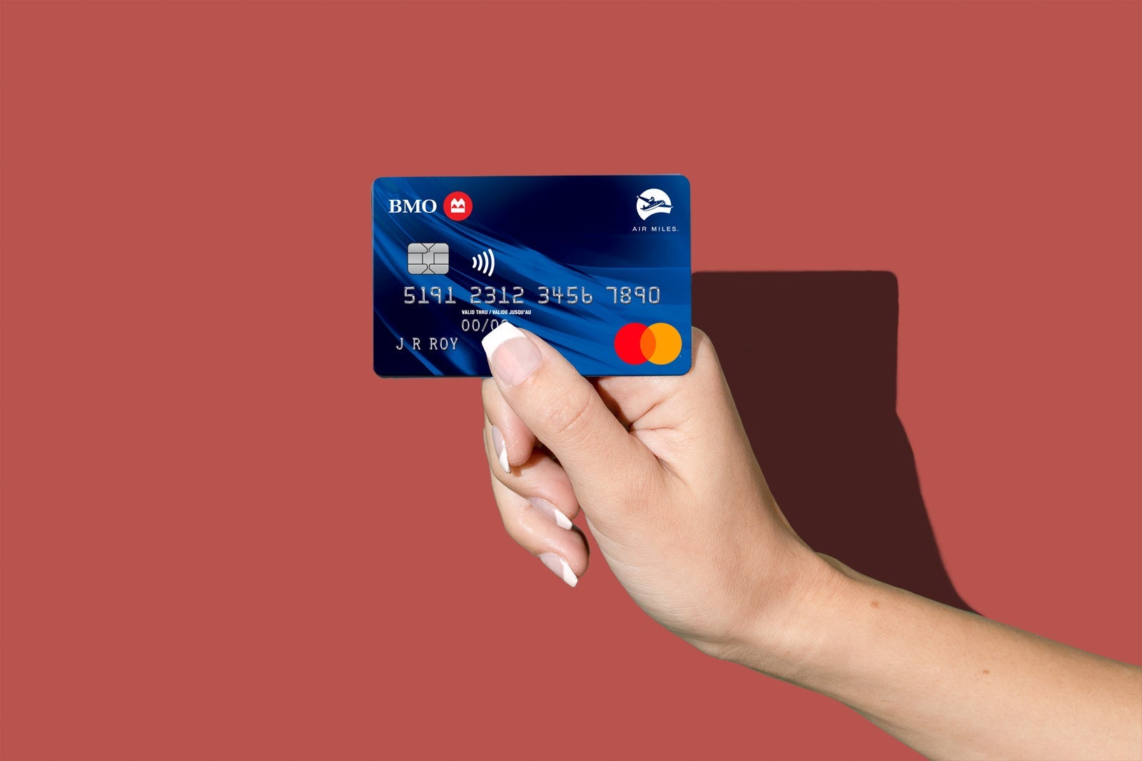 a hand holds a credit card