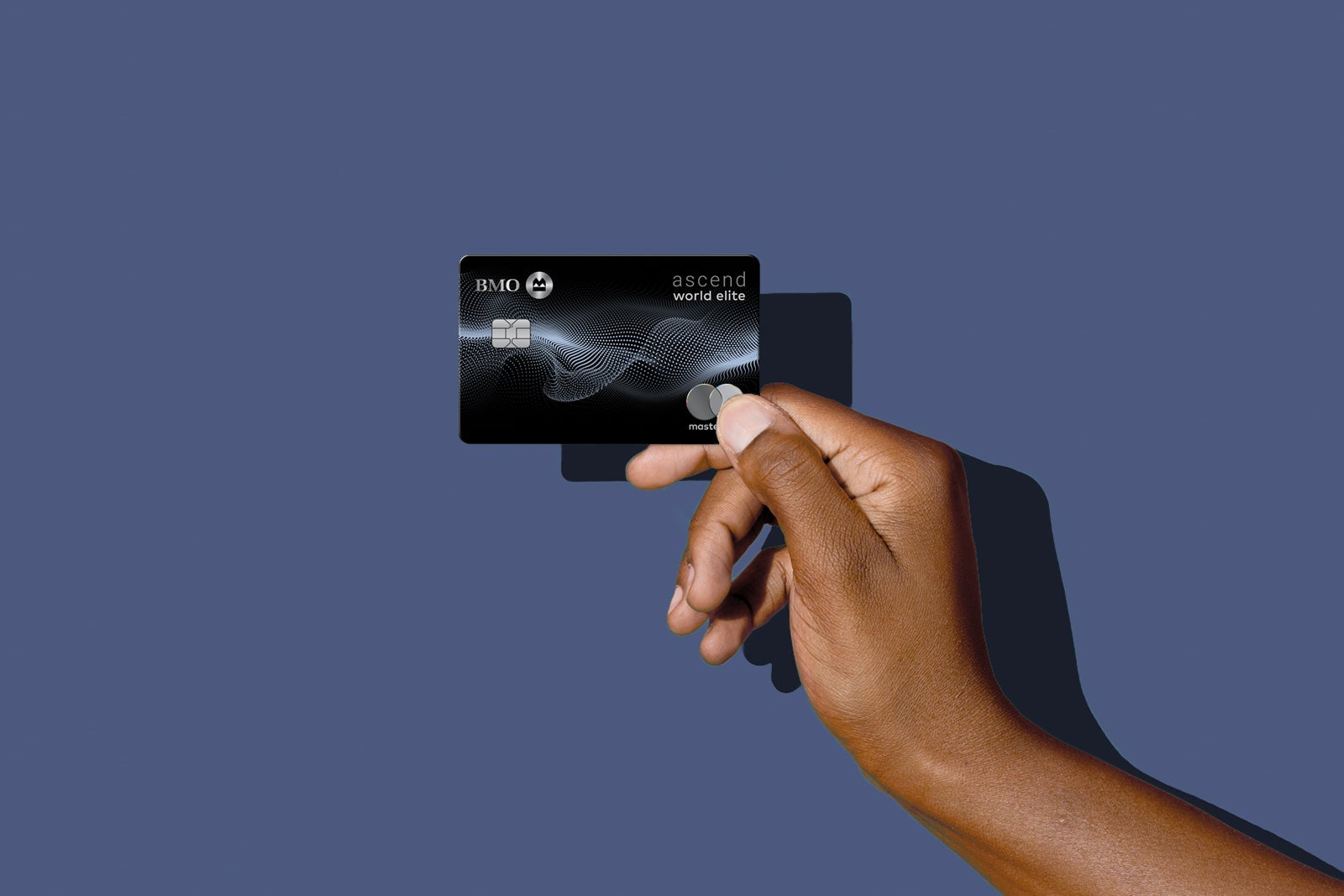 a hand holds a credit card