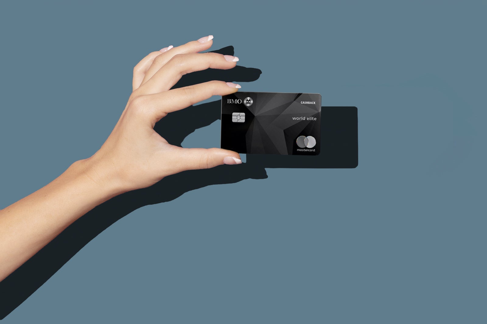 a hand holds a credit card