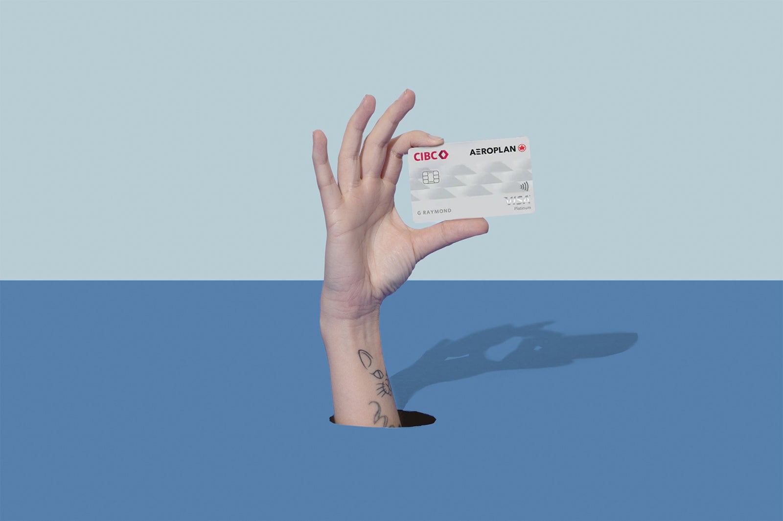 a hand holds a credit card