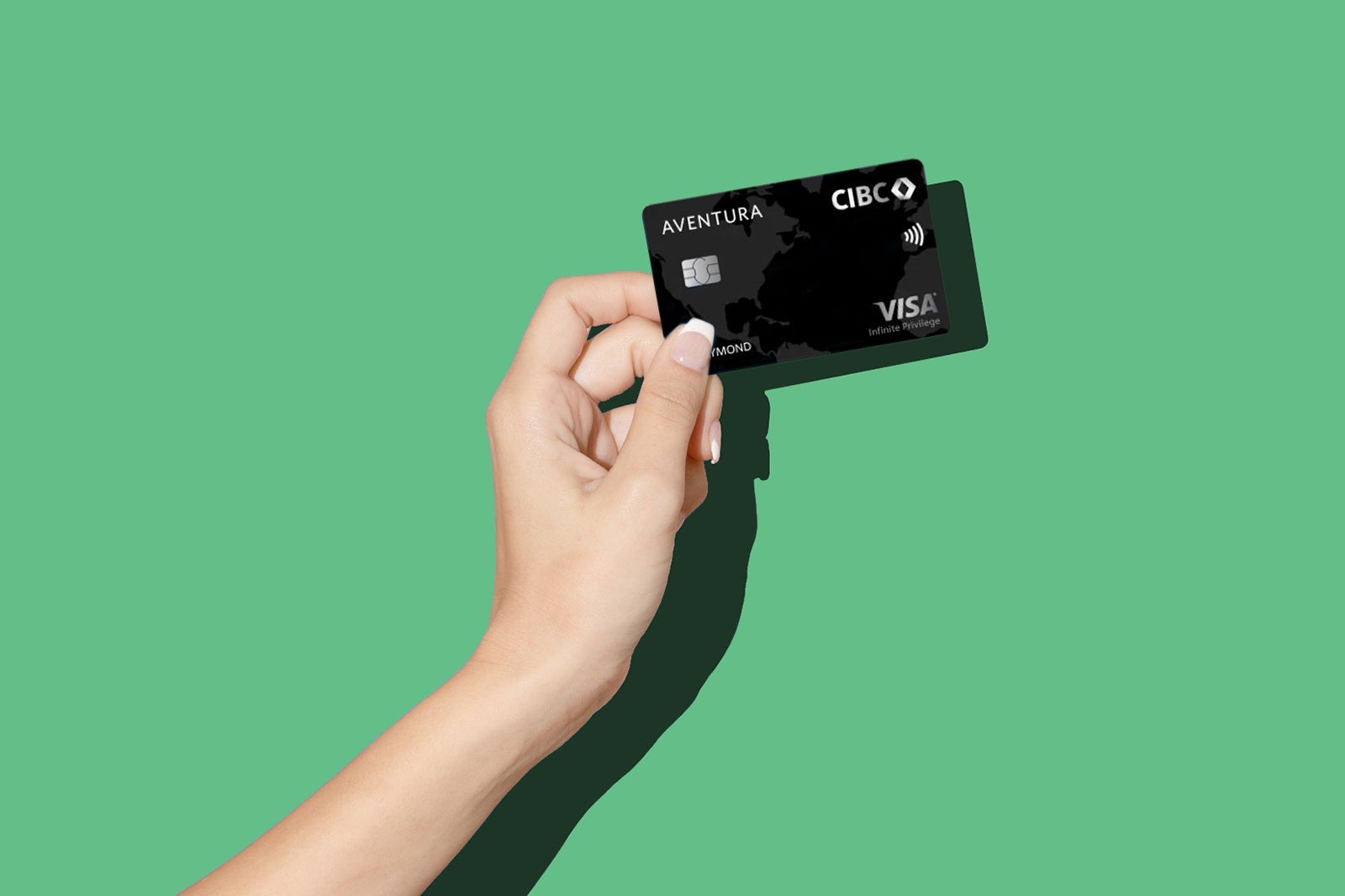 a hand holds one of the best travel credit cards in Canada