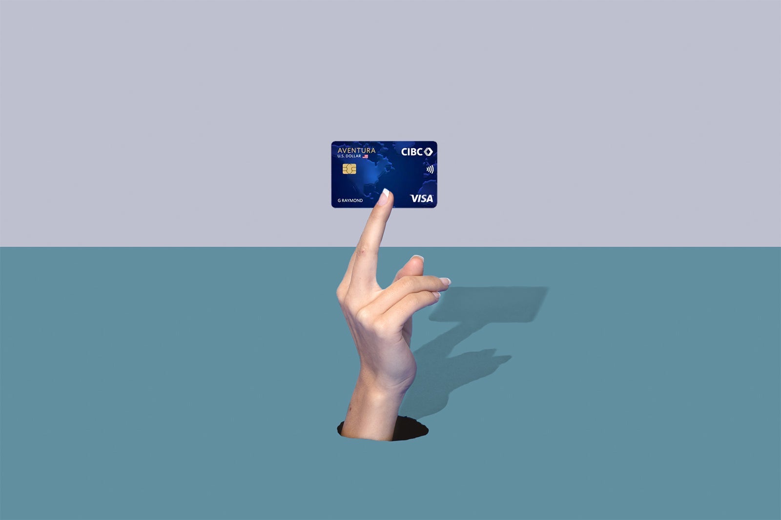 a hand holds a credit card