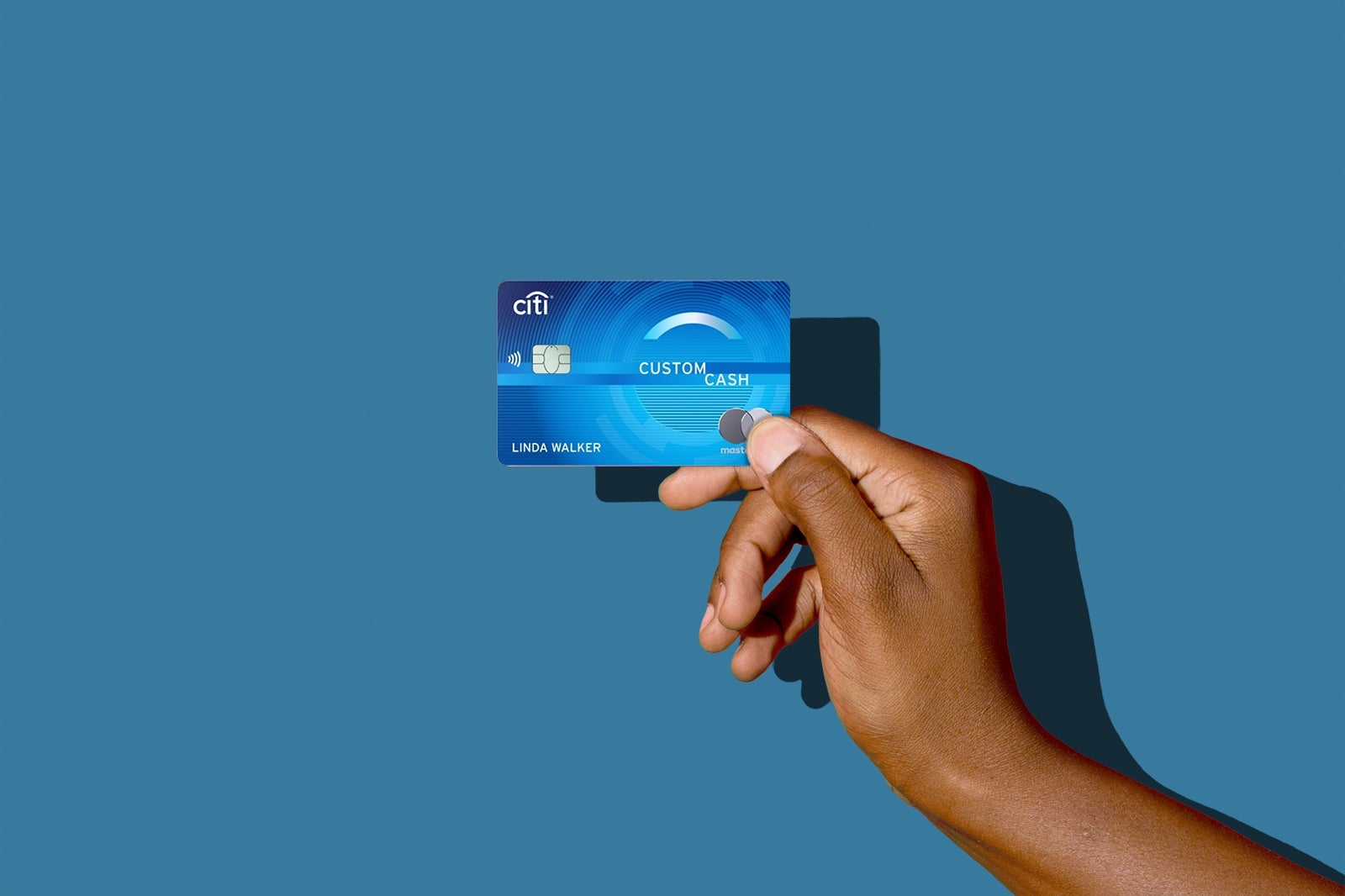 a hand holds a credit card