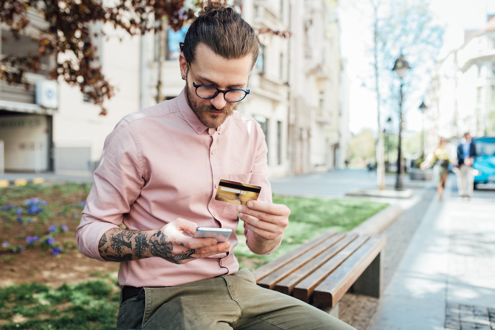 a young person makes a phone call while holding a credit card