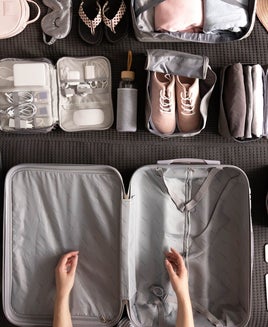 Woman Packing Suitcase For Travelling