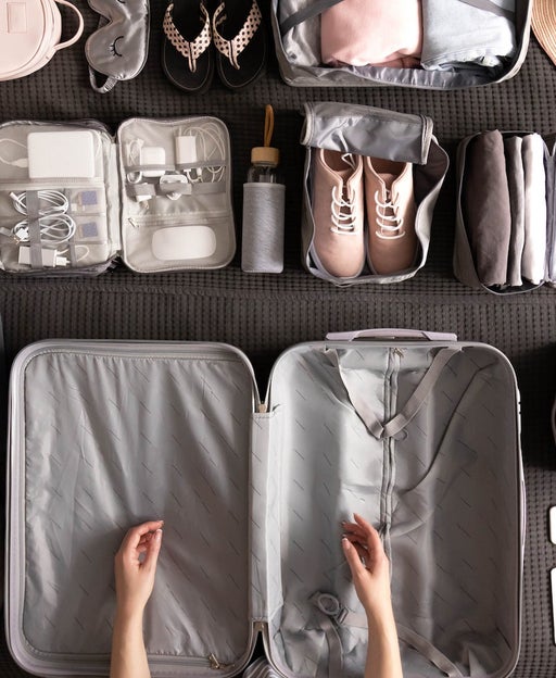 Woman Packing Suitcase For Travelling
