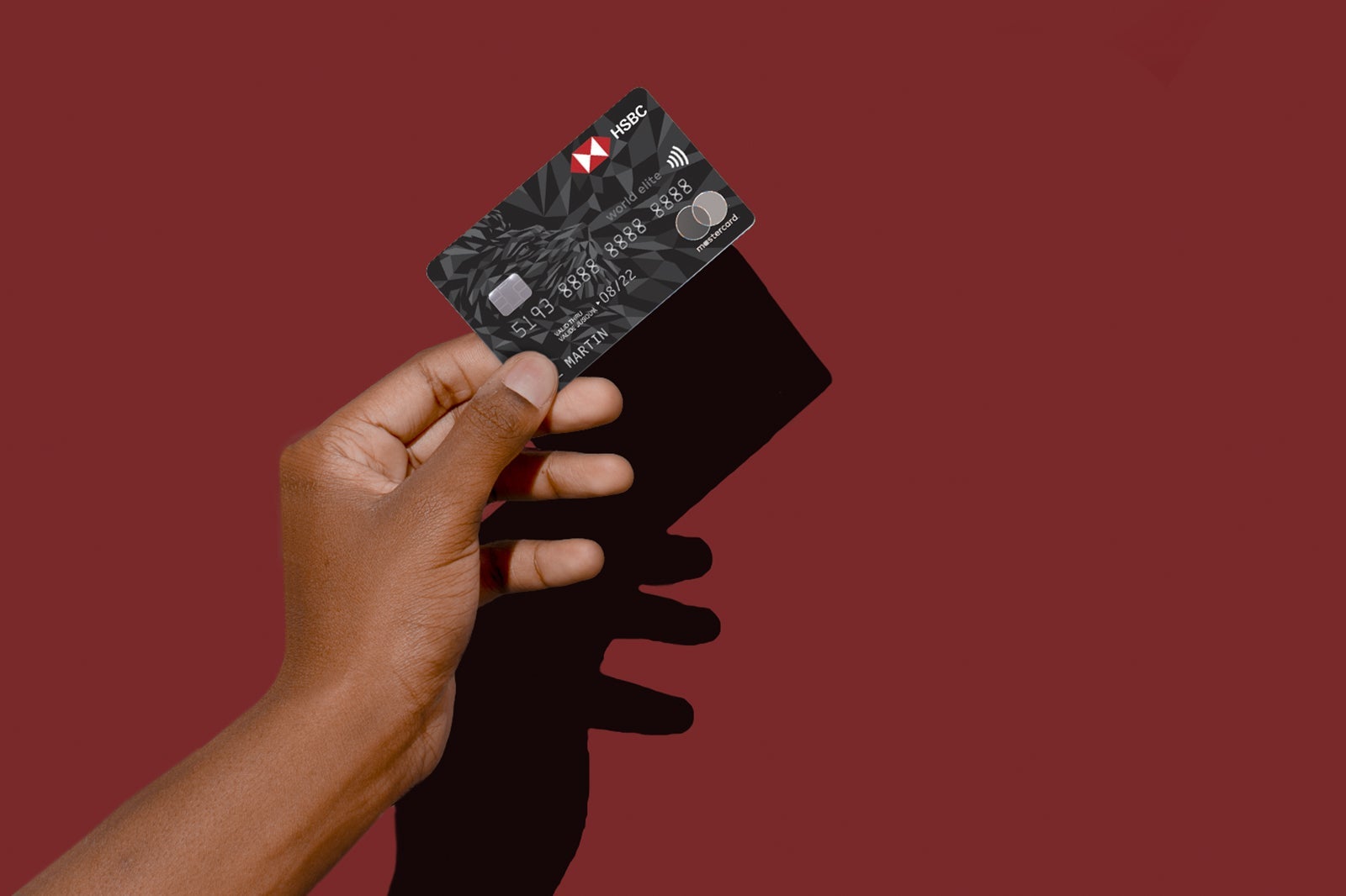 a hand holds a credit card