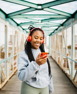 Woman using a smartphone and headphones