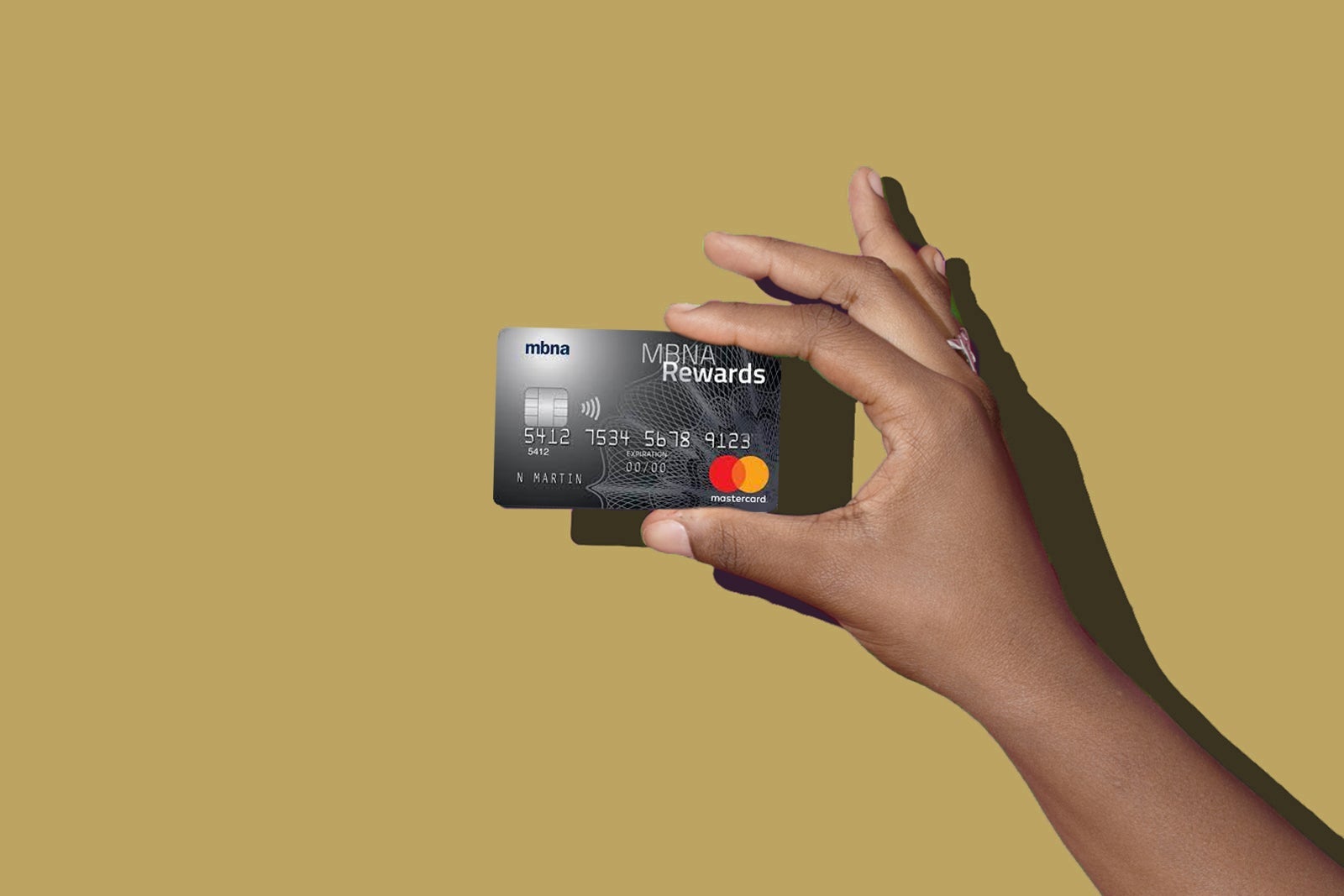a hand holds a credit card