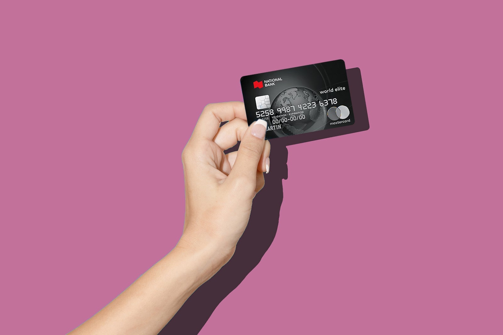 a hand holds one of the best travel credit cards in Canada