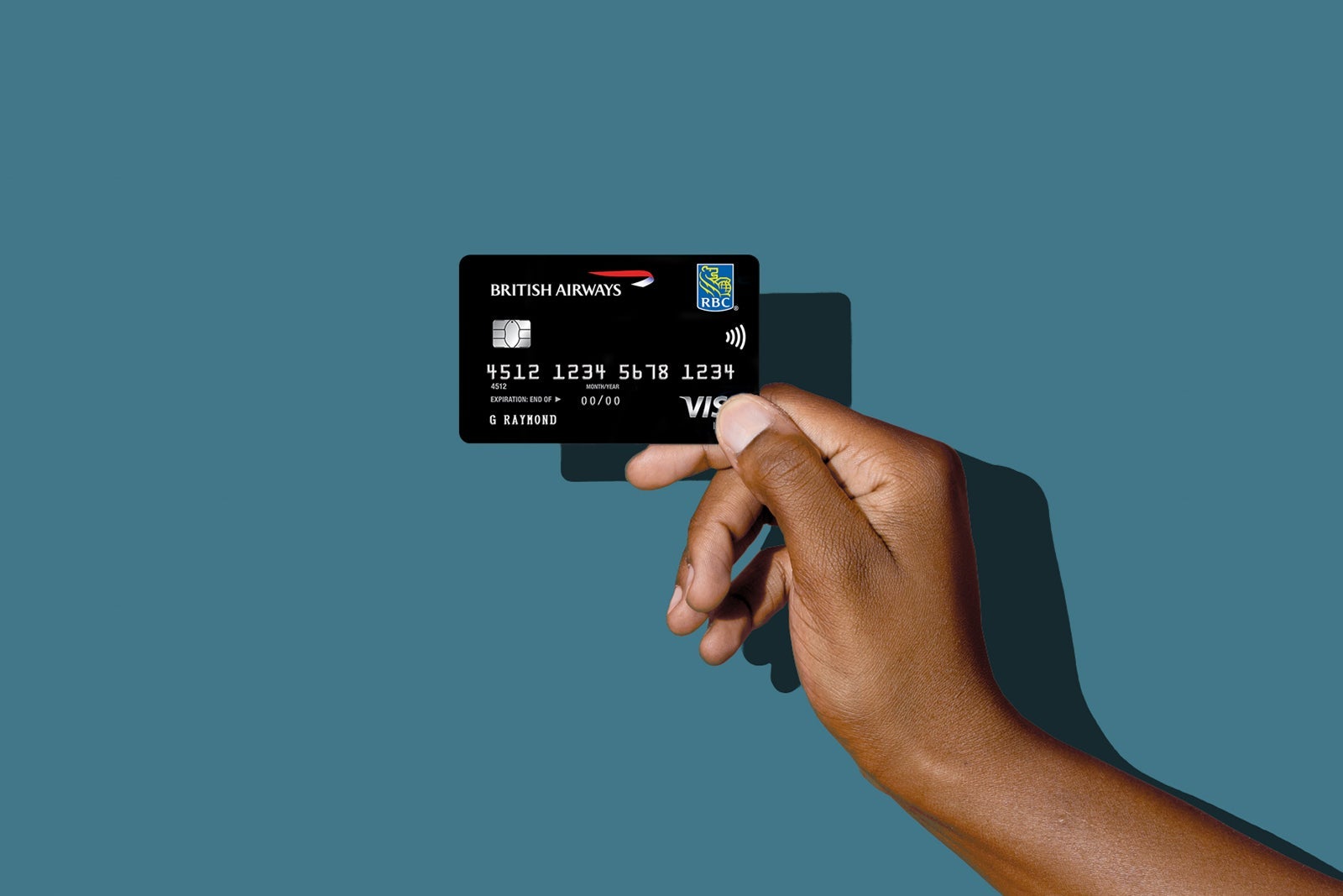 a hand holds a credit card