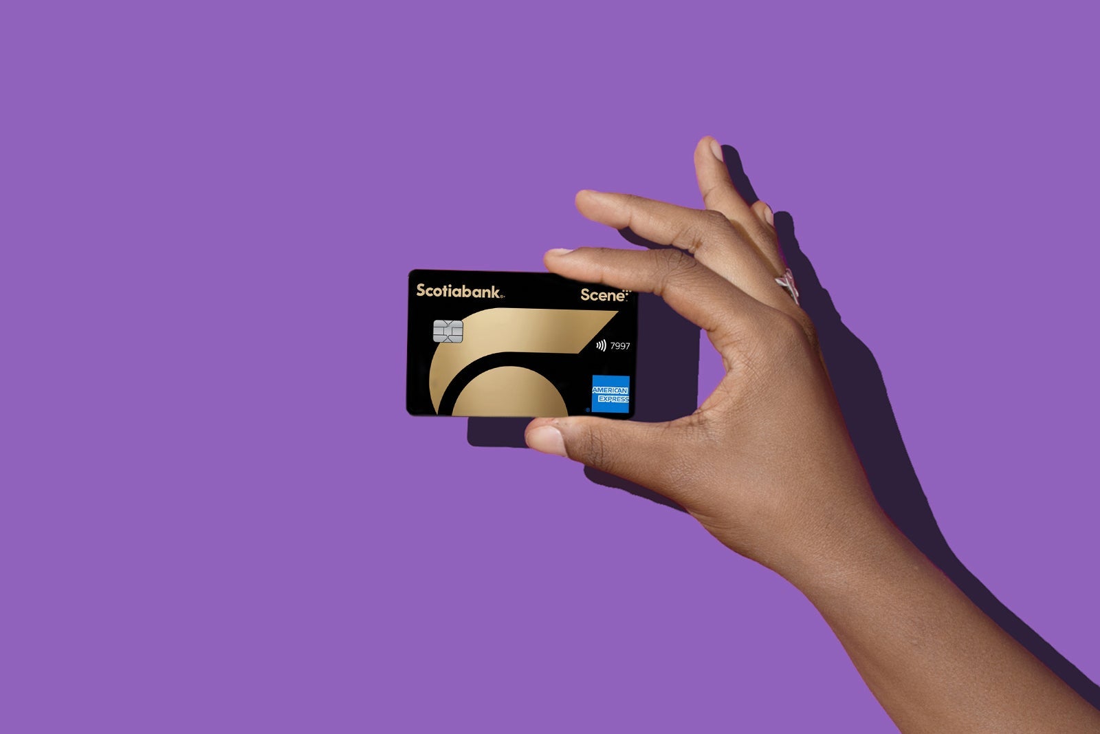 a hand holds a credit card