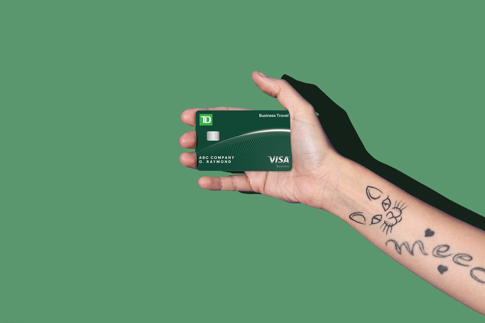 a hand holds a credit card