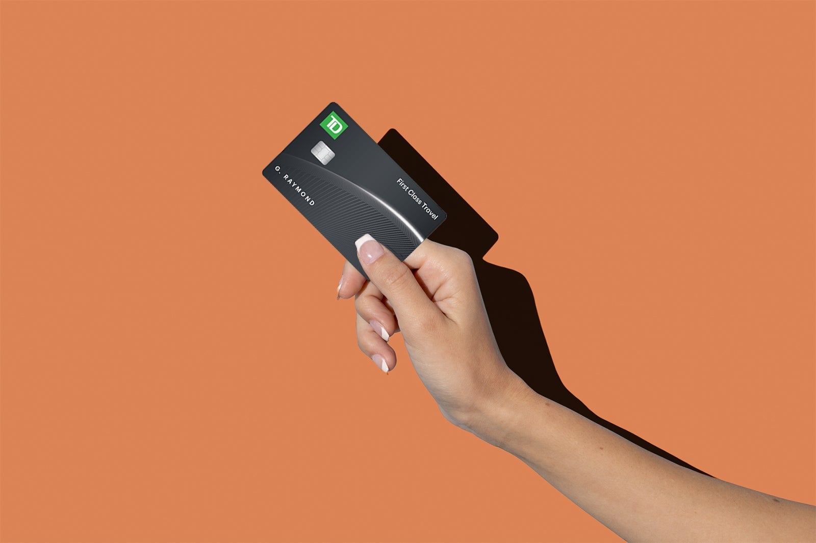 a hand holds a credit card