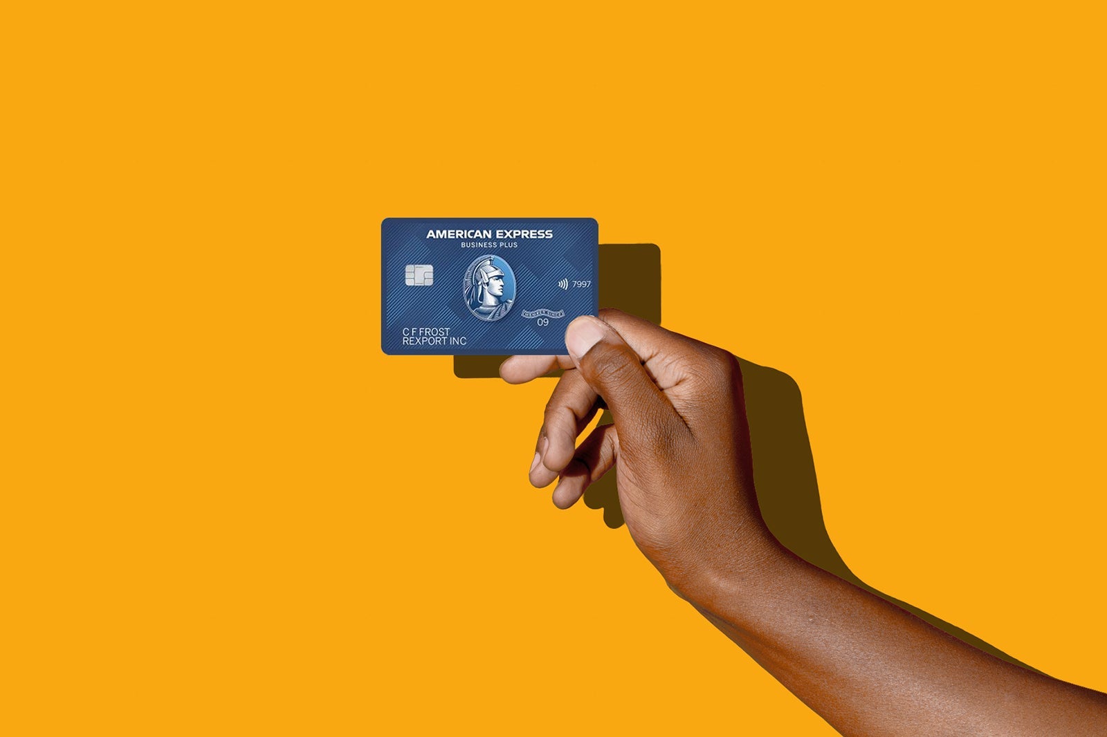 a hand holds a credit card