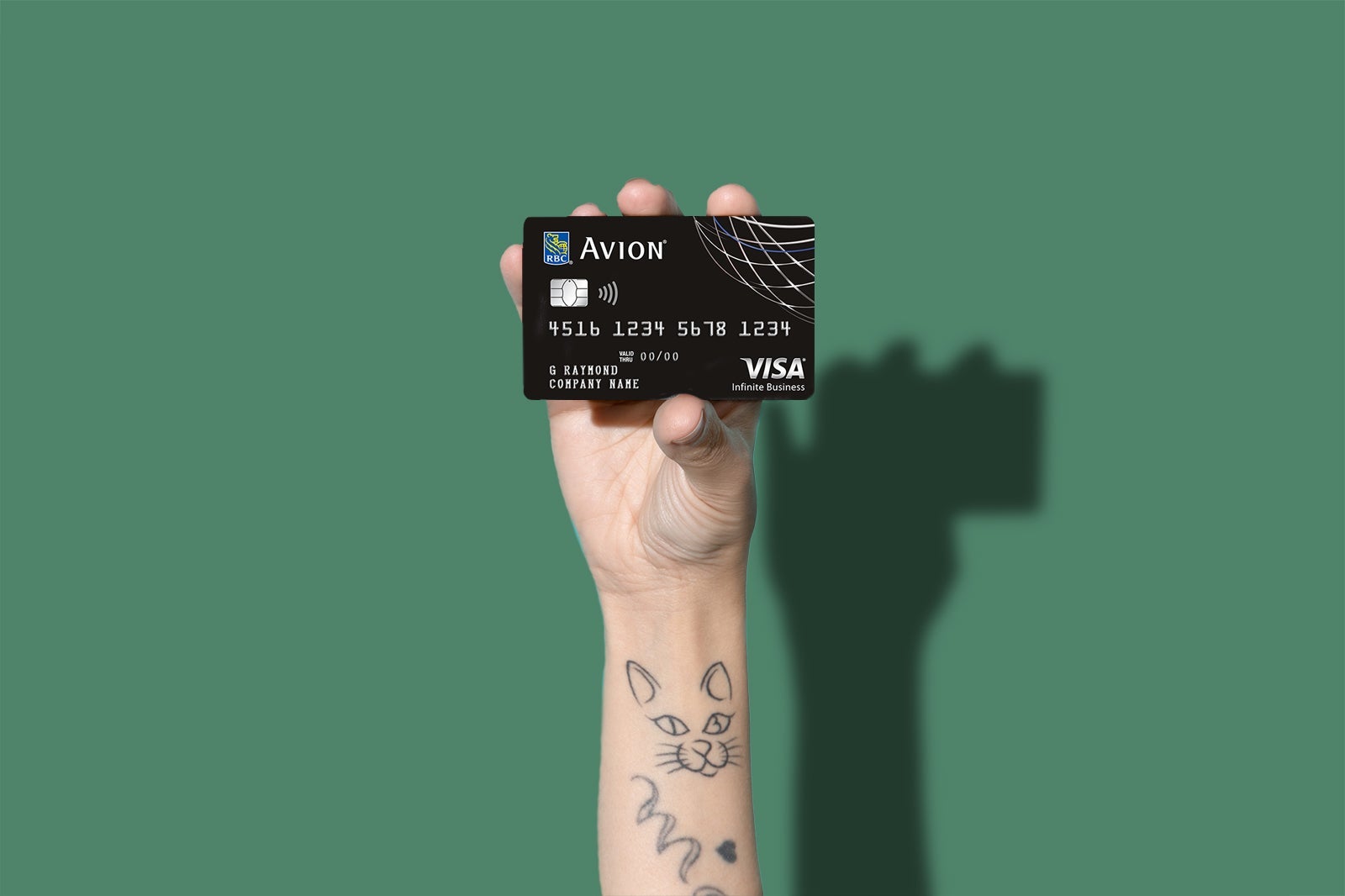 a hand holds a credit card