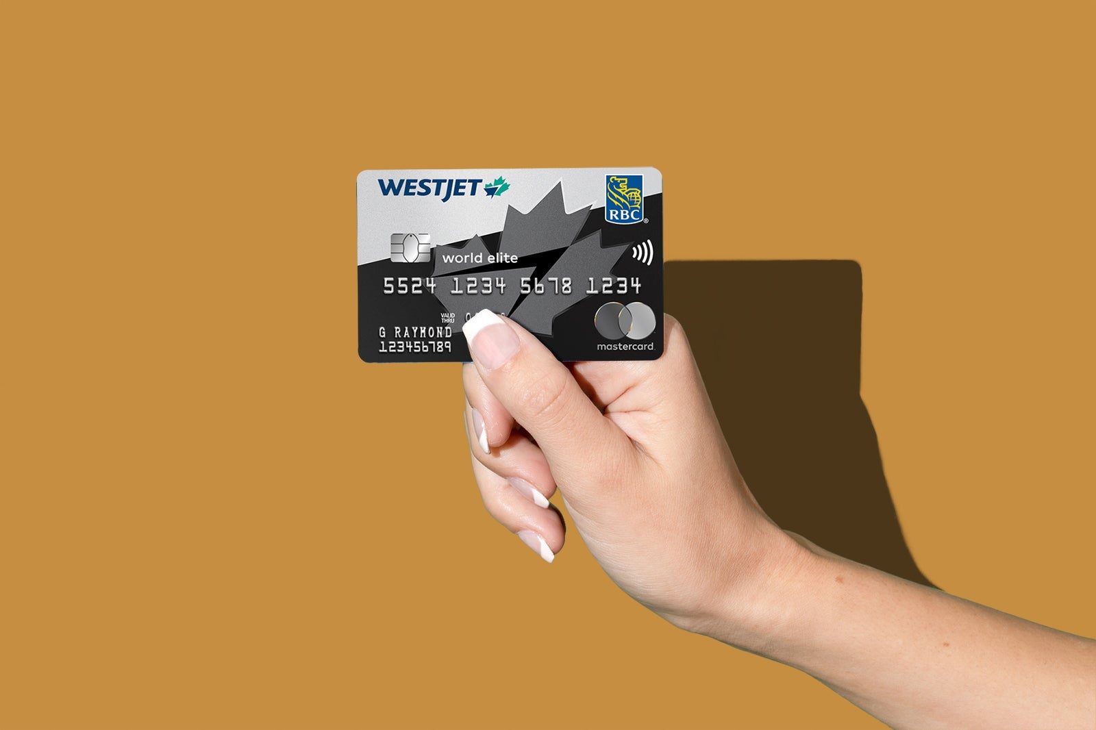 a hand holds a credit card