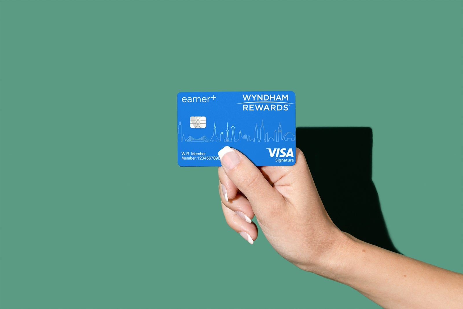a hand holds a credit card