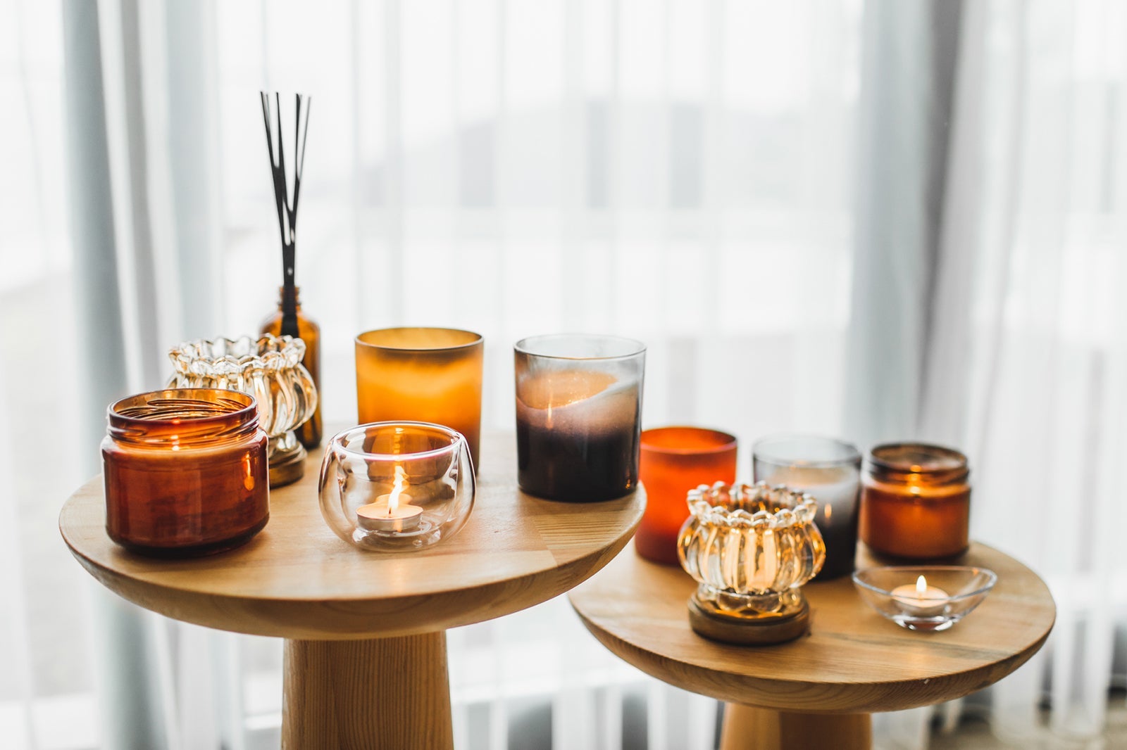 Two small tables with lit candles on them