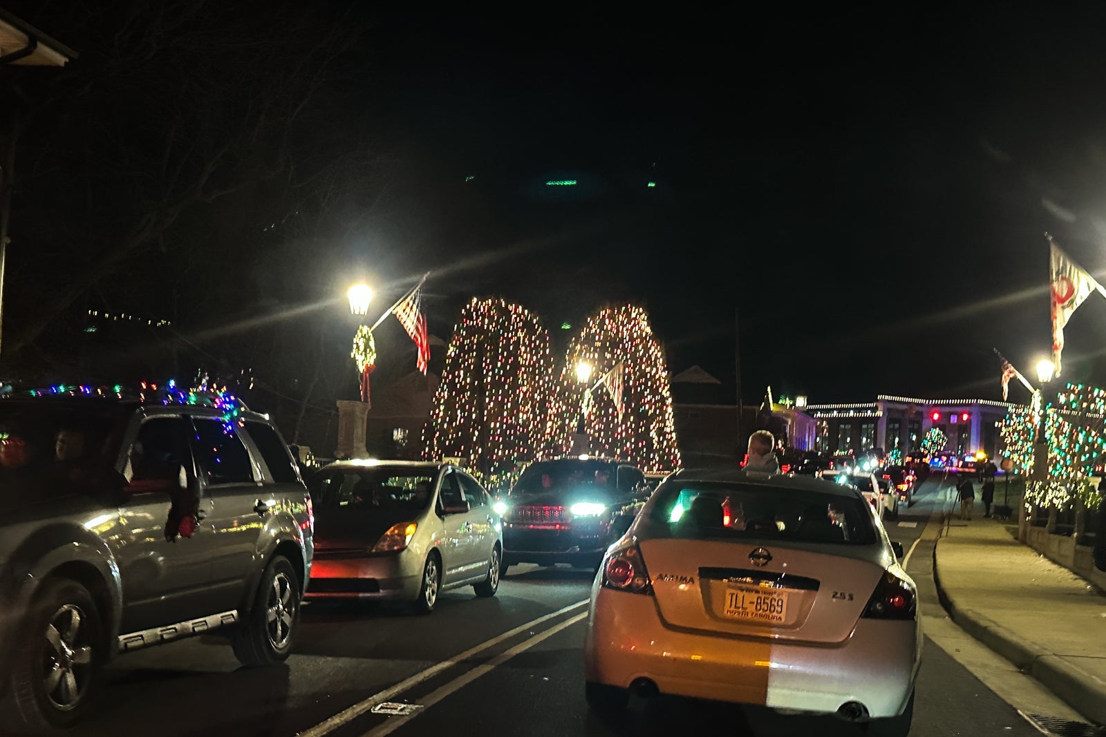 cars in traffic to see Christmas lights in a small town