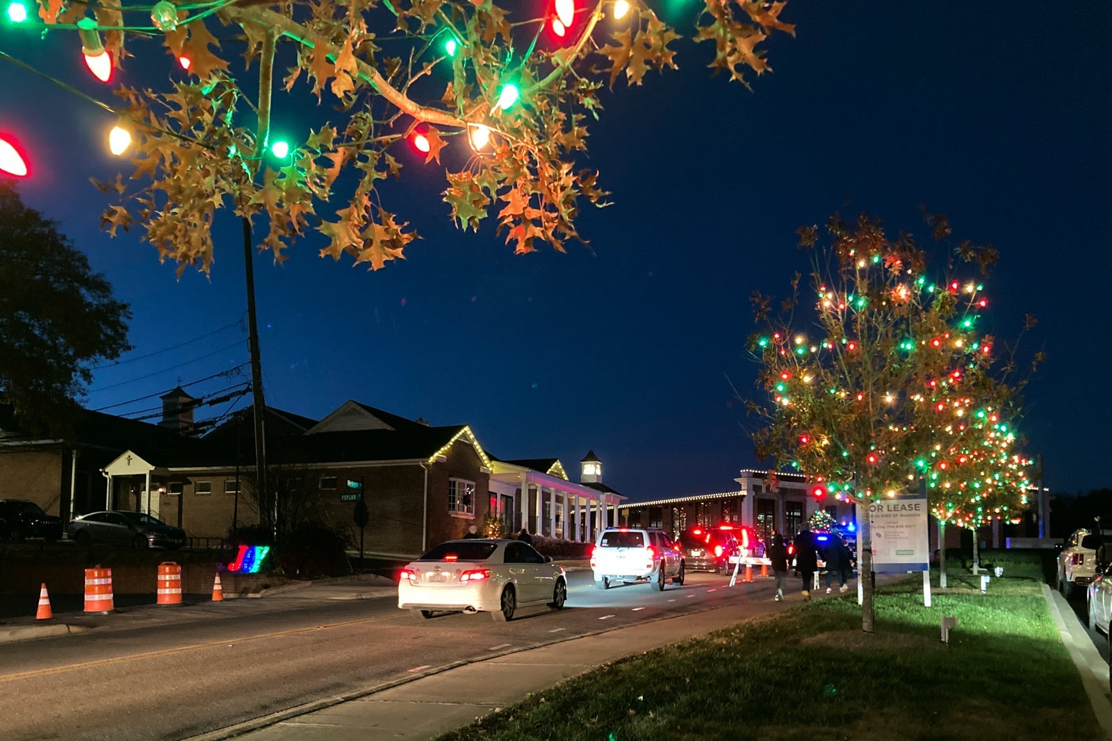 cars in traffic to see Christmas lights in a small town