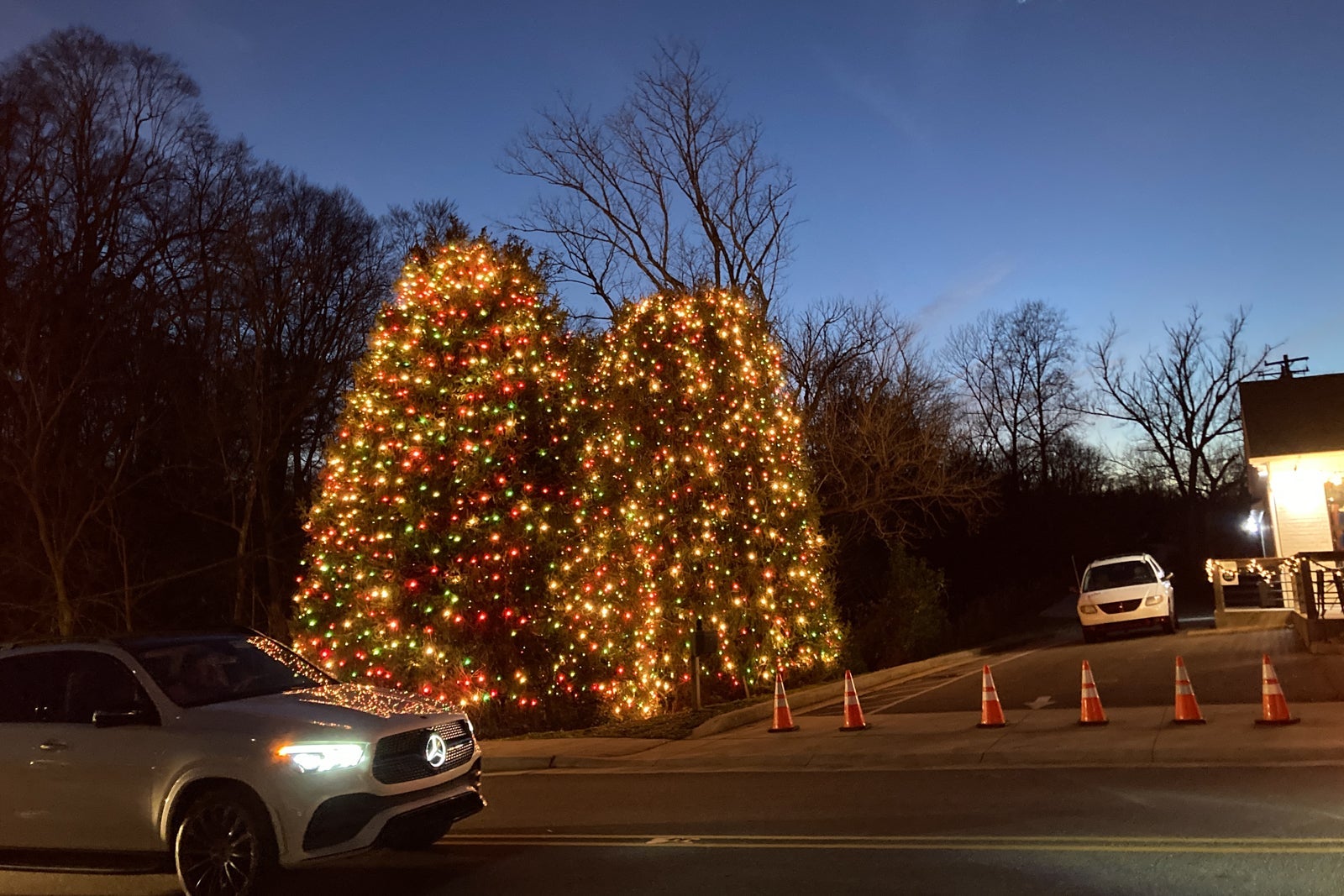 cars in traffic to see Christmas lights in a small town