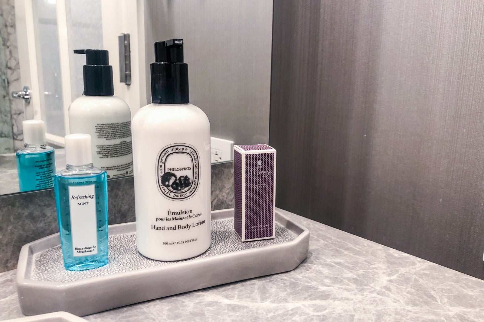 Photo carousel of the bathroom at The Ritz Carlton Half Moon Bay, incudling the bathrobe, shower, bath tub and toiletries.