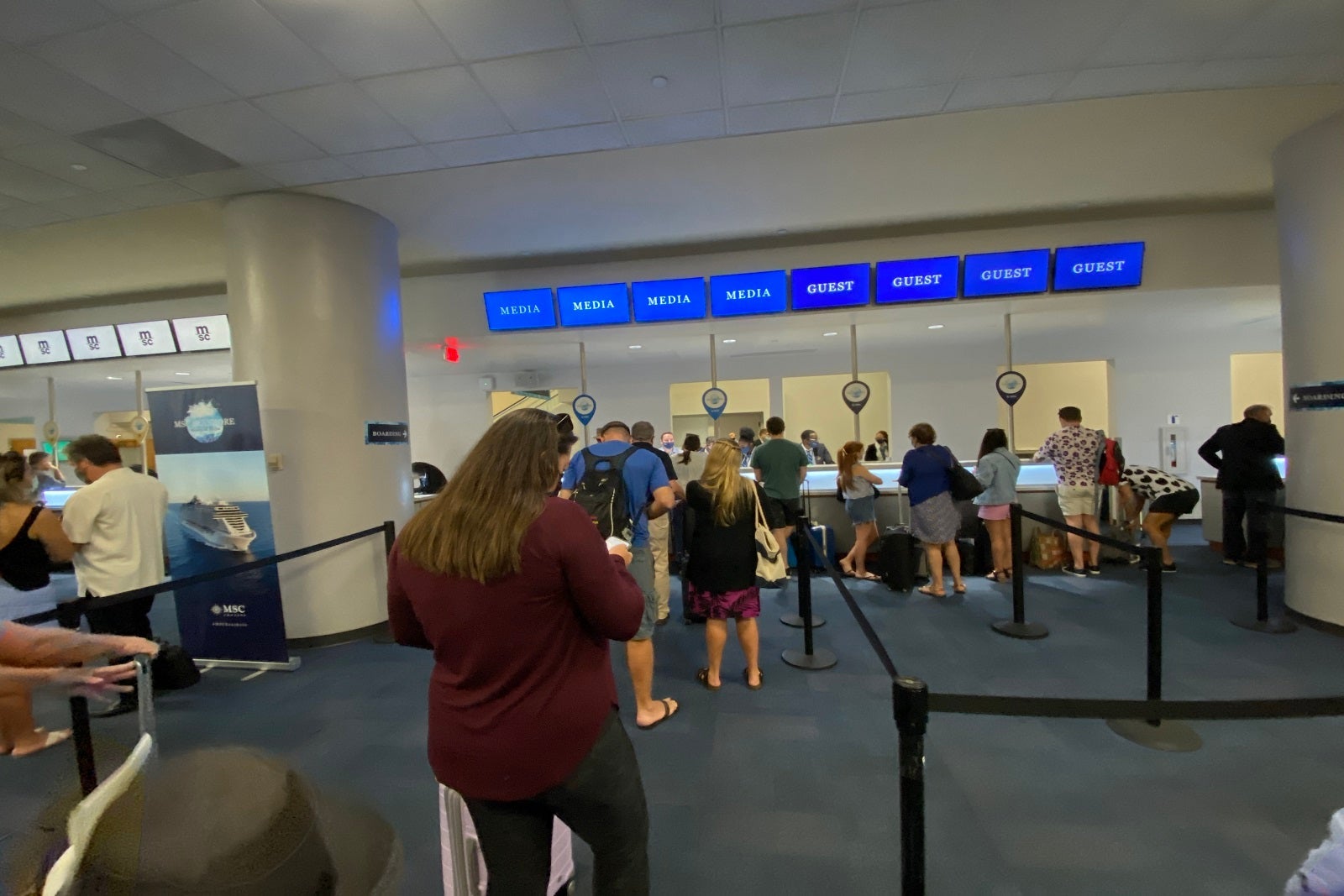 Passengers waiting in line to check in for a cruise