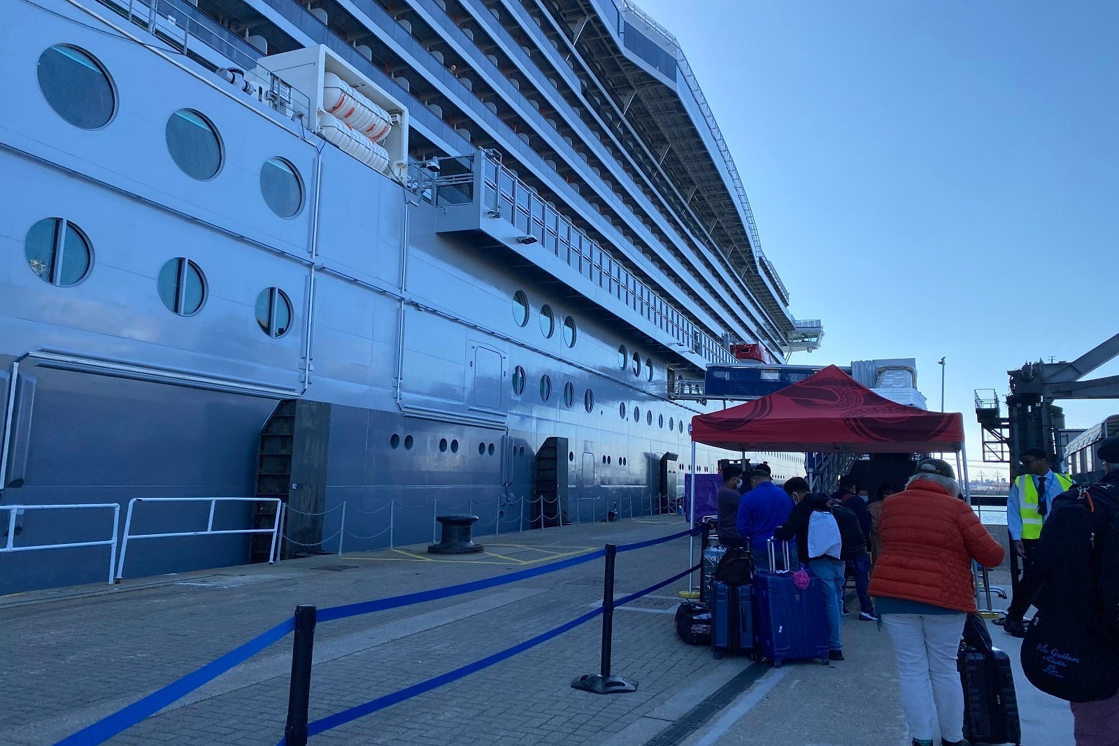 Passengers entering the gangway to board a cruise ship