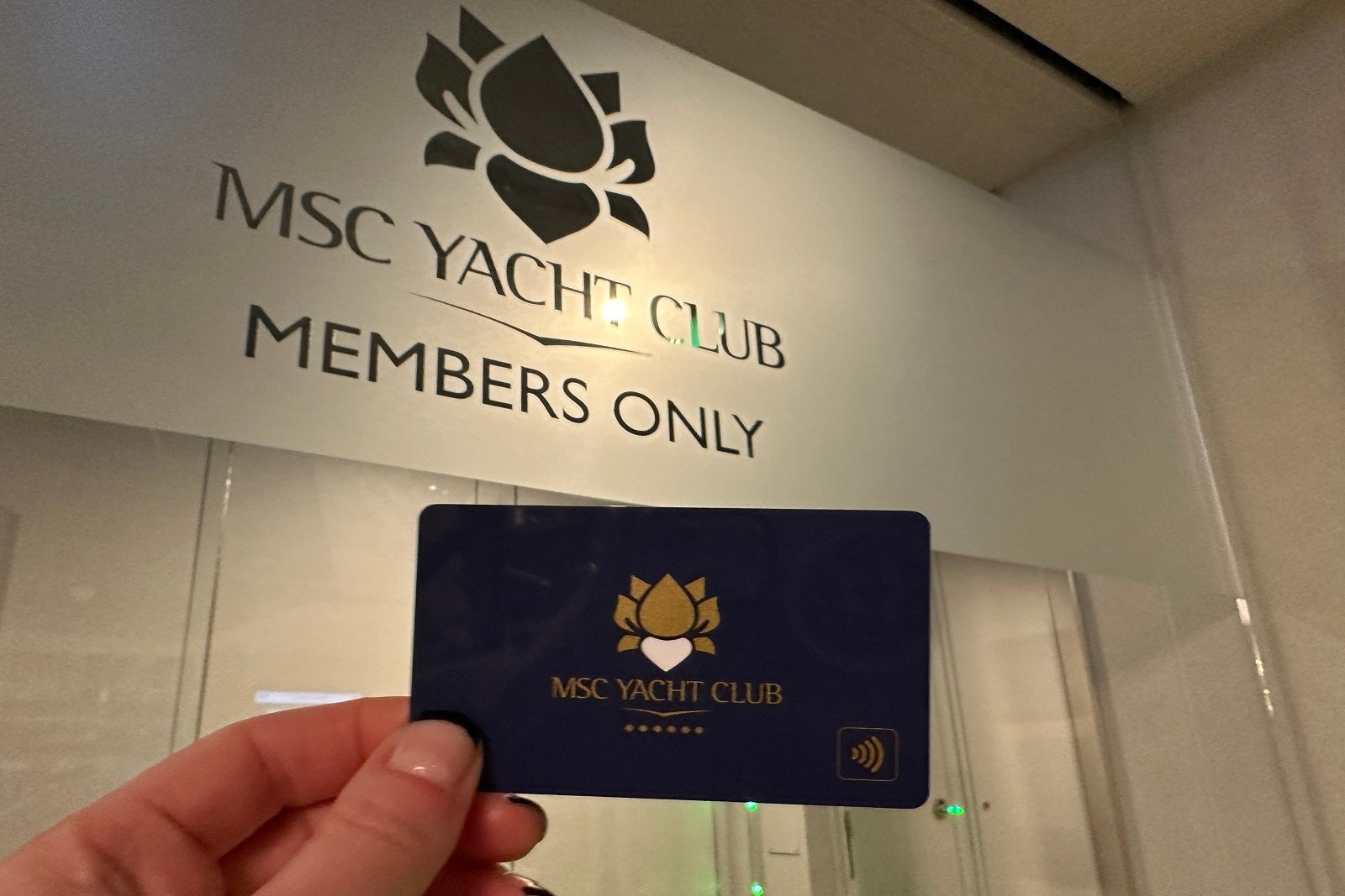 Entrance to the Yacht Club on MSC Cruises' MSC Seascape and hand holding a key card