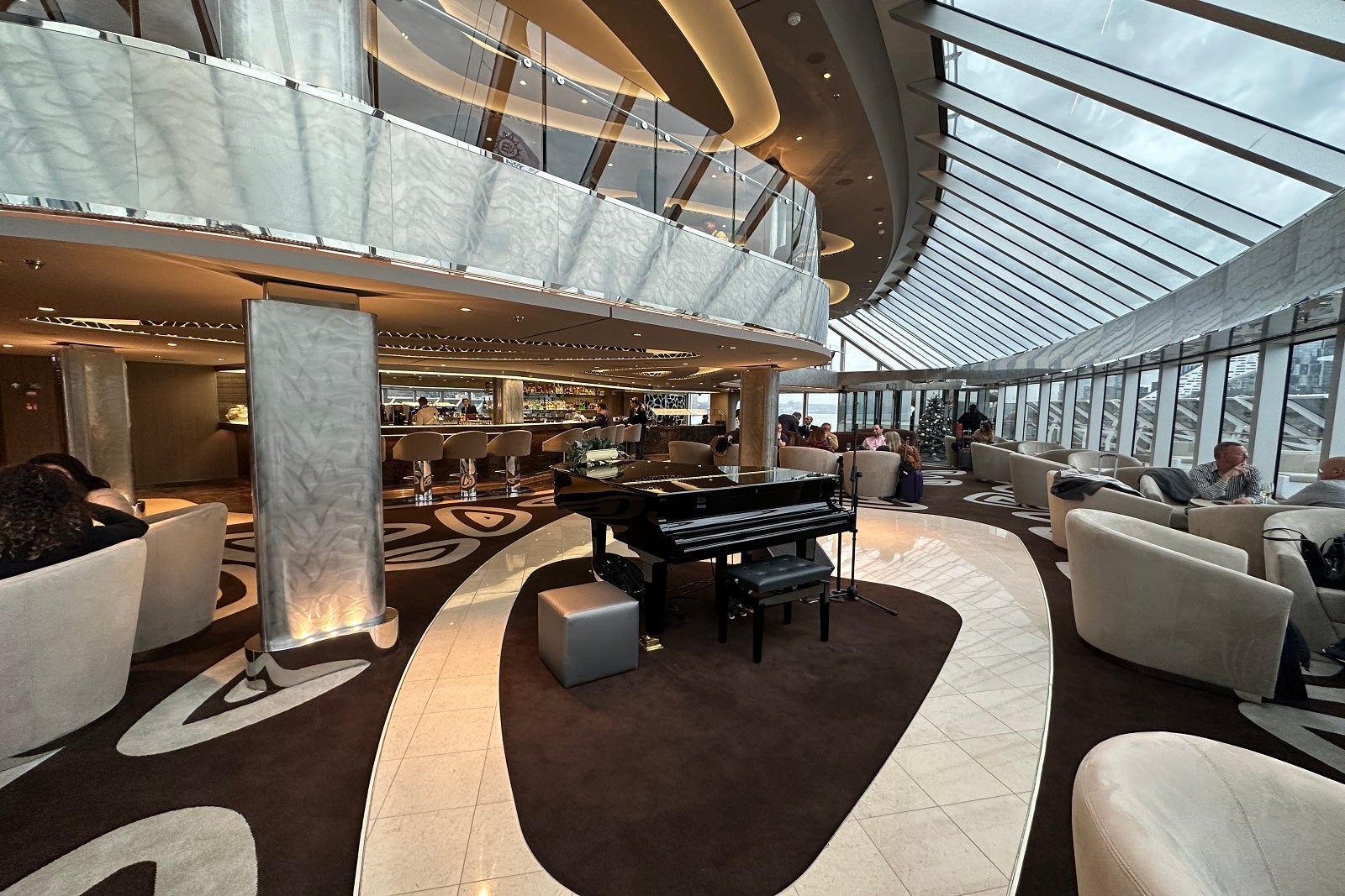 The exclusive two-deck Yacht Club bar, lounge and restaurant on MSC Cruises' MSC Seascape with piano in the center