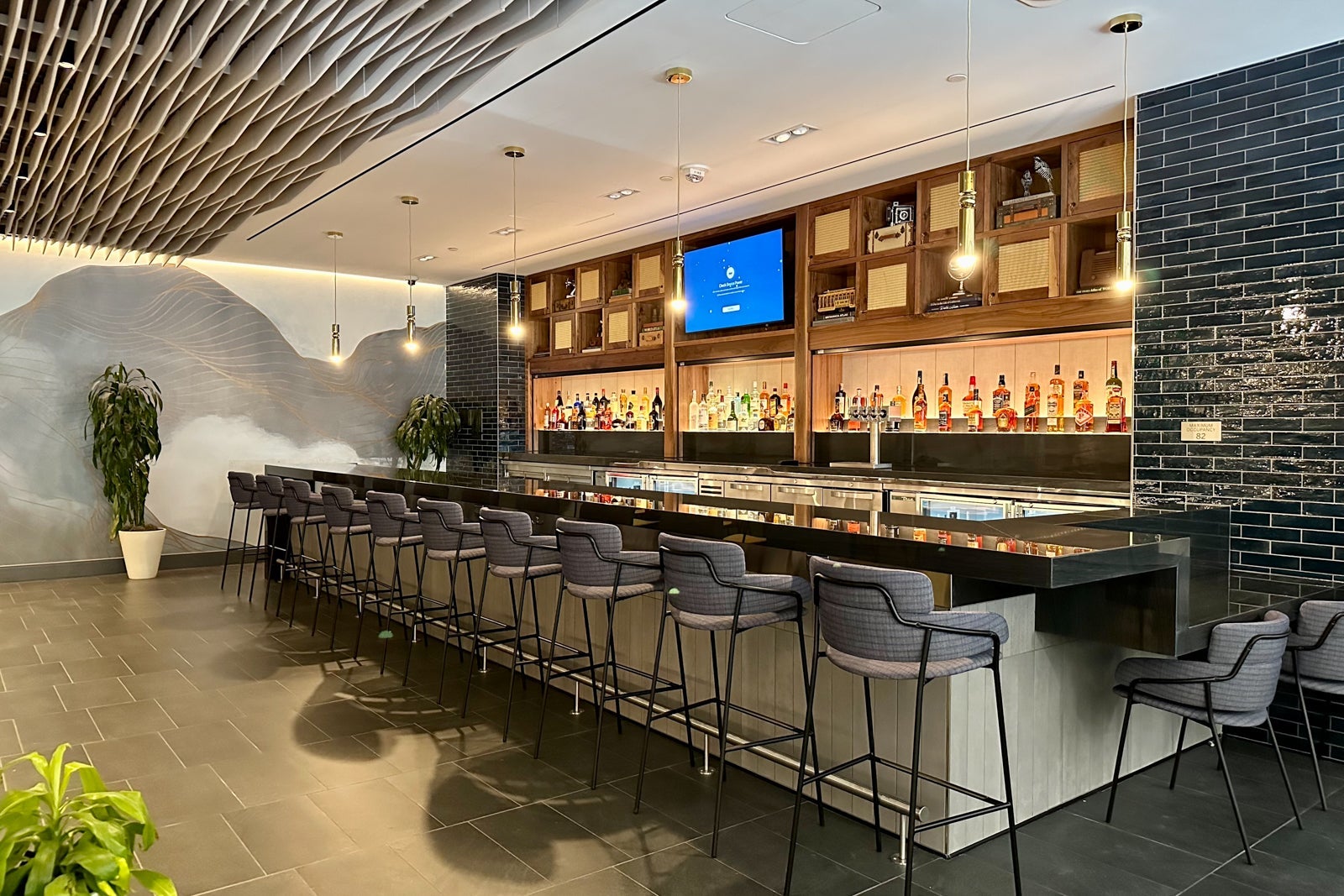a large bar area inside an airport lounge