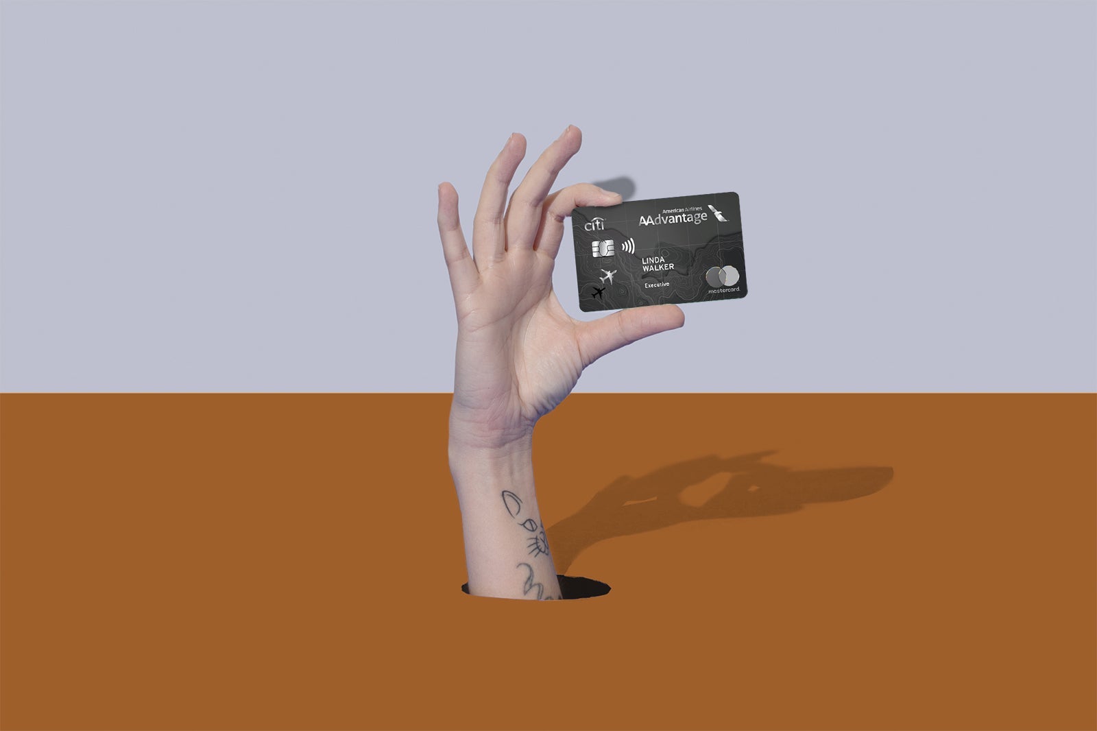 a hand holds a credit card