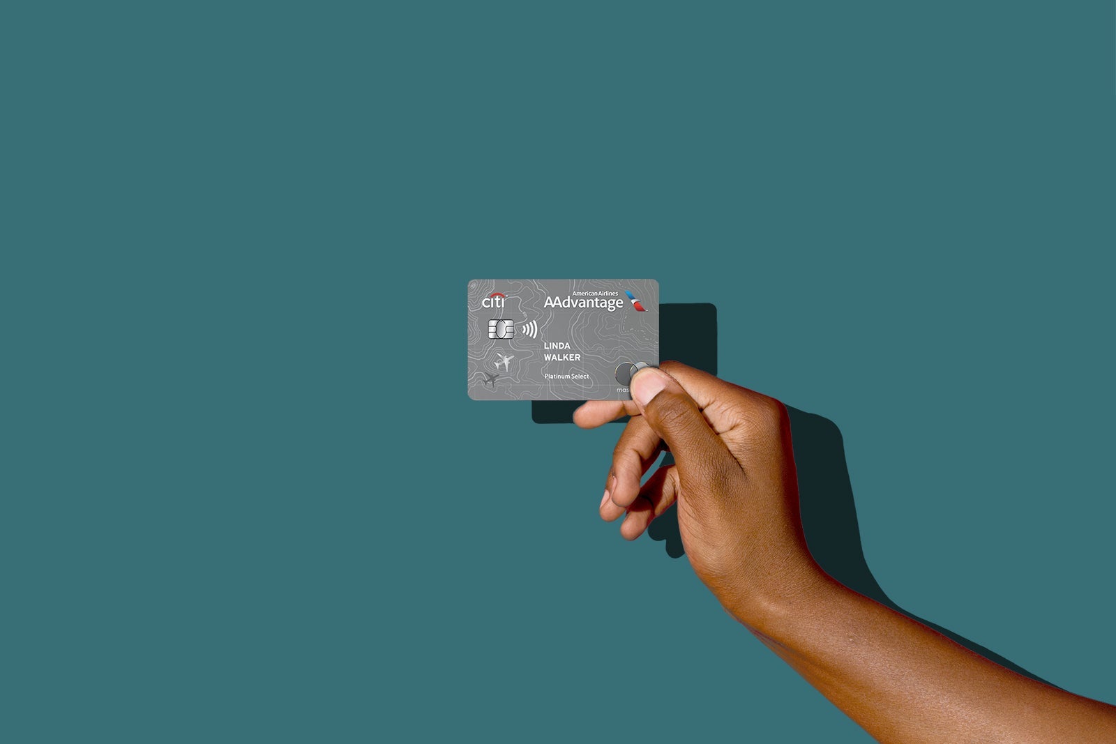 a hand holds a credit card