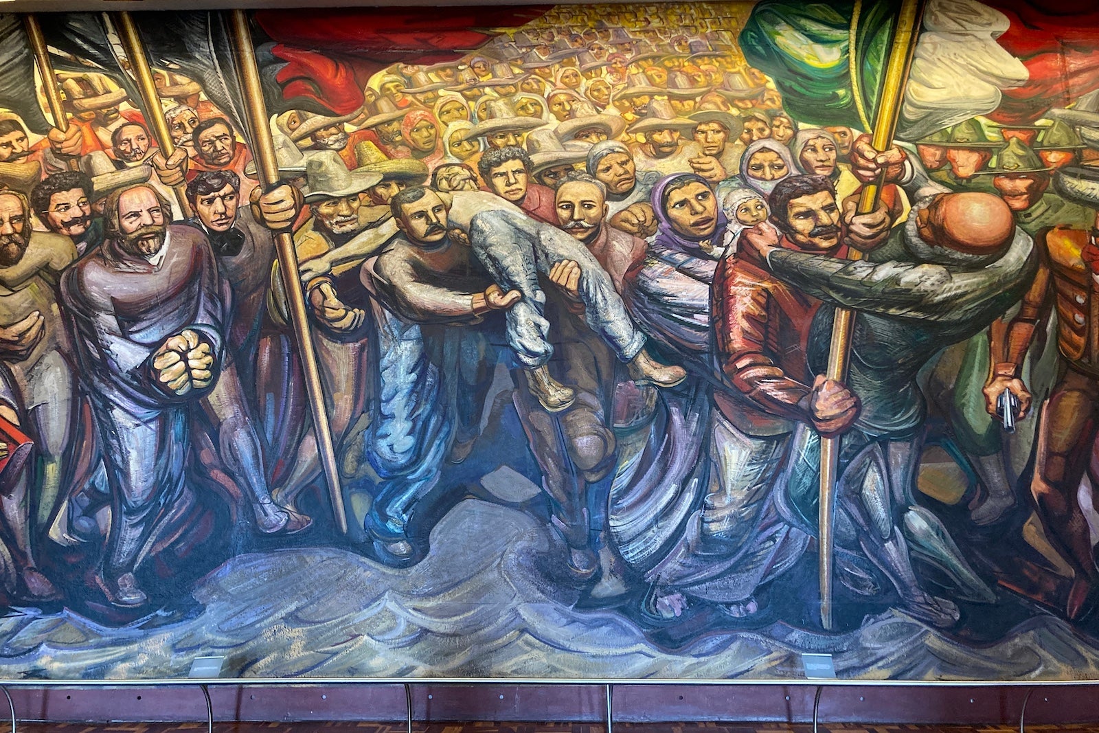 a large painting shows scenes from the Mexican revolution