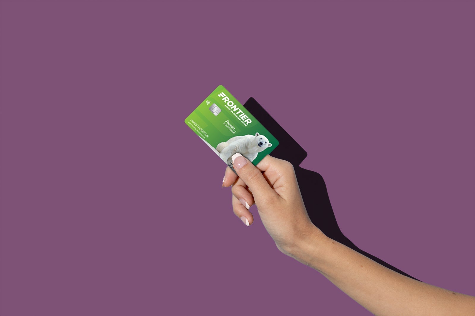 a hand holds a credit card